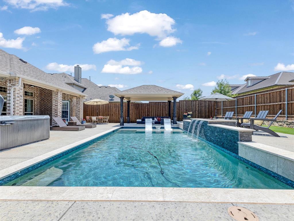 BACK ON THE MARKET! Just in time for Summer! Your Dream Home with a sparkling pool is here! Get ready to fall in love with this 5-bedroom, 4-bath beauty, complete with a sparkling pool, custom arbor, and built-in fire pit—your private retreat for relaxing weekends and unforgettable gatherings. The thoughtfully designed layout includes a primary suite, dedicated office with custom built-ins, and a full guest bath on the main floor, with four additional bedrooms and a media room upstairs—perfect for families, guests, or multi-generational living. A 3-car garage offers plenty of space for vehicles, tools, and toys, while inside, you’ll find two spacious living areas, a cozy fireplace, and an island kitchen featuring a butler’s pantry and abundant counter space—ideal for entertaining or everyday cooking. Hosting a dinner party or enjoying a casual meal? You’ve got options with formal and informal dining areas. Need a quiet place to work or study? The home office is ready to be your productive oasis. When it’s time to unwind, head upstairs to your media room, fully equipped with a projector and speaker system—movie night just got an upgrade! The primary suite is a true escape, with a spa-like bath, separate shower, garden tub, and an oversized walk-in closet that’s ready for your next shopping spree. Located just minutes from top shopping, dining, and entertainment—and zoned to the top-rated Prosper ISD—this home is the perfect blend of luxury and location. Plus, enjoy amazing community amenities: pool, playground, flex court, and scenic walking trails, all designed to complement your active lifestyle.