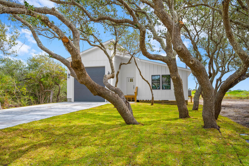 Enjoy coastal living in a beautiful brand-new home in the heart of Rockport. A short golf cart ride takes you to downtown, the Arts District, local restaurants and shops, Rockport Beach, and Water Street for evening cruises along the bayfront.  Inside, 1,520 square feet of thoughtfully designed living space features an open-concept layout, a custom kitchen with beautiful quartz, shiplap accents and upgraded tile throughout the kitchen and bathrooms. Beautifully finished window casings and abundant storage add thoughtful detail throughout. With 2,265 square feet under roof, there's room to relax, entertain, and enjoy easy indoor-outdoor living.  The standout 35-by-16-foot boat garage, complete with a 12-by-12-foot door, offers exceptional space for your boat and coastal gear. Beautifully built and invitingly priced, this home makes coastal luxury feel within reach. Whether you're looking for a full-time residence, a weekend escape, or a short-term rental opportunity, this Rockport home is ready to welcome you.