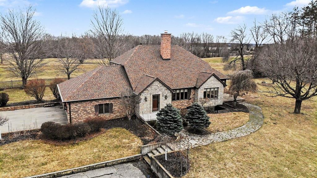 This 4-bedroom, 3.5-bath exquisite Tudor home sits on 10.5 wooded acres with a pond, frontage on hole #6 of the Pleasant Hills golf course and is just a couple of minutes from the Mt. Pleasant city limits. The home features a spectacular kitchen with an island, granite countertops, top of the line commercial grade Wolf gas range, and Sub-Zero refrigerator. Other wonderful features include two primary suites on the upper level with walk in closets, a mostly finished basement with egress windows and with wet bar, wine cellar, beverage fridge, and a main floor with woodburning fireplace in living room, formal and informal dining, sunroom, and laundry room. The home is heated with an energy efficient open loop geothermal system, and the indoor heat pump was replaced in 2023. Recent updates include new roof with gutters and downspouts in 2022 and a water filtration system. So, whether you are an outdoor enthusiast, golf enthusiast, or just like peace and quiet, this property and home will meet all of those needs and more!