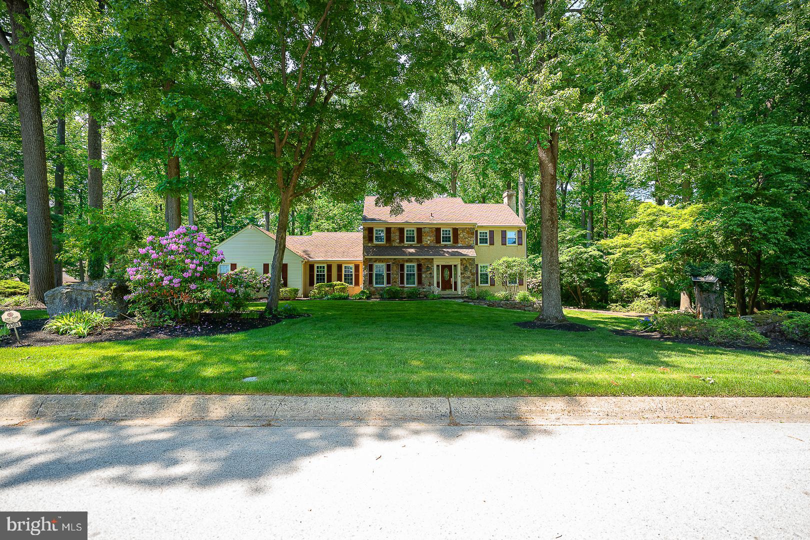 Set on a beautifully landscaped and remarkably private 0.84-acre lot in Greene Countrie, this spacious 4-bedroom, 2.5-bath Colonial offers approximately 3,452 square feet, a traditional floor plan, and an exceptional opportunity to create a home tailored to your own style.The welcoming center-hall foyer is framed by substantial woodwork, beautifully maintained hardwood floors, and plantation shutters found throughout the home. A formal dining room sits to the left, while the generously proportioned living room to the right features a fireplace and windows on multiple sides.The spacious kitchen offers abundant cabinetry, granite surfaces, a large center island, and a professional-style gas range. An adjoining breakfast area provides ample room for everyday dining and opens directly to the deck. Just beyond the kitchen, the inviting family room features exposed beams, a striking stone gas fireplace and views of the surrounding greenery.The family room leads to a three-season room with a vaulted wood-paneled ceiling, tiled floor and walls of glass overlooking the wooded setting. Multiple doors open to the expansive deck, creating an effortless connection between the home and its peaceful outdoor spaces. A separate first-floor office provides a quiet and versatile place to work, read or pursue hobbies.Upstairs, the spacious primary suite includes a private bathroom, while three additional bedrooms—one currently arranged as an office—share a full hall bath. Generous closets, hardwood flooring through the hallway and abundant natural light add to the home’s appeal.The large unfinished basement provides excellent storage and significant potential for future recreation, fitness, workshop or additional living space.Outside, mature trees, established plantings, stone garden paths and layered landscaping create an unusually private setting. The expansive deck offers multiple areas for dining, entertaining or simply enjoying the surrounding landscape.Built in 1975 and carefully maintained by its longtime owners, this home offers generous room sizes, quality hardwood floors, distinctive architectural details and a beautiful setting. Bring your vision and update this well-loved property for its next chapter.Interior pictures coming soon.