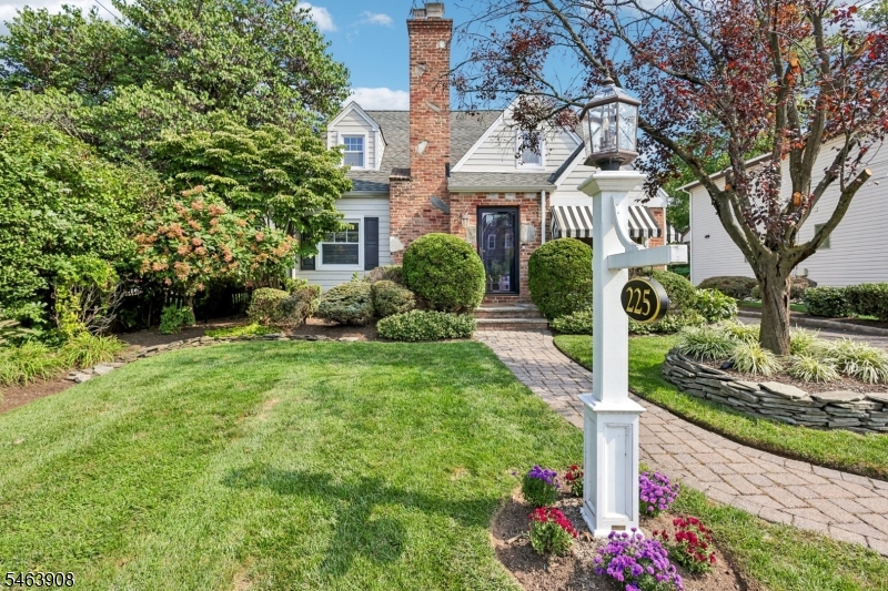 Charming, inviting, and full of character, this 3-bedroom, 2.1-bath Cape Cod is the kind of home that instantly feels special. Step inside to a warm and welcoming living room with a wood-burning fireplace, beautifully connected to the dining room. The lovely eat-in kitchen features granite countertops, beadboard backsplash, stainless steel appliances, and a farmhouse sink a perfect gathering spot for everyday moments and entertaining. A cozy enclosed porch adds to the home's charm with the exposed brick walls and awning on exterior windows, offering a peaceful place to sip your morning coffee or unwind at the end of the day. A first-floor bedroom and powder room complete the main level. Upstairs, you'll find two oversized  bedrooms and a full bath, while the finished basement provides even more space with a recreation room, bonus room, and gorgeous full bath. Outside, the magic continues with a covered rear porch, paver patio, and detached one-car garage, all set against a picturesque backdrop. Conveniently located near schools, downtown Westfield, and NYC transportation, this delightful home offers charm, comfort, and a wonderful place to make memories.