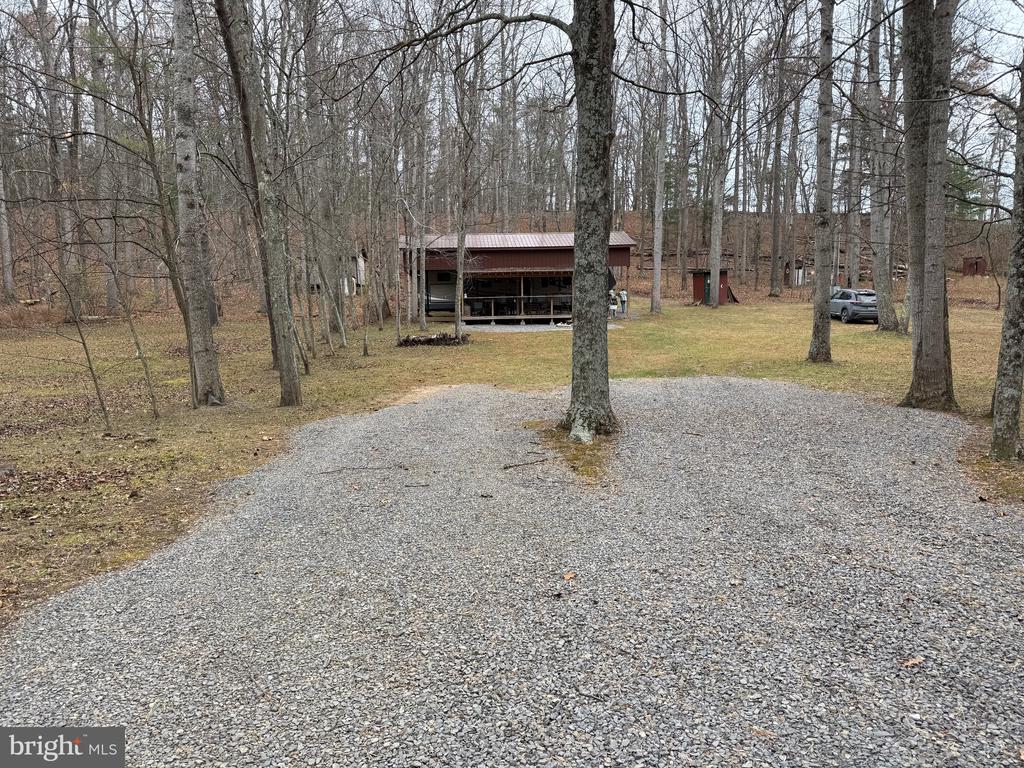 Enjoy River Life! 1.04 acre (3 lots) with 60' of frontage along the beautiful Cacapon River. This lot has everything you need to enjoy long weekends. Well, Septic, Electric, Storage Building, for all your camping equipment, 2016 - Sandpiper model #365SAQB - 4 slide outs and all the furniture & appliances. Central Vac, 1.5 baths (full bath has a full-size shower), bunk house (4 beds), master bedroom has a closet and hookup for washer & dryer. Camper has outside cooking area. Camper is covered with stick-built carport and has a large porch for relaxing. Plus, Frontier fiber optic internet to watch TV, make WIFI calls and play games.
