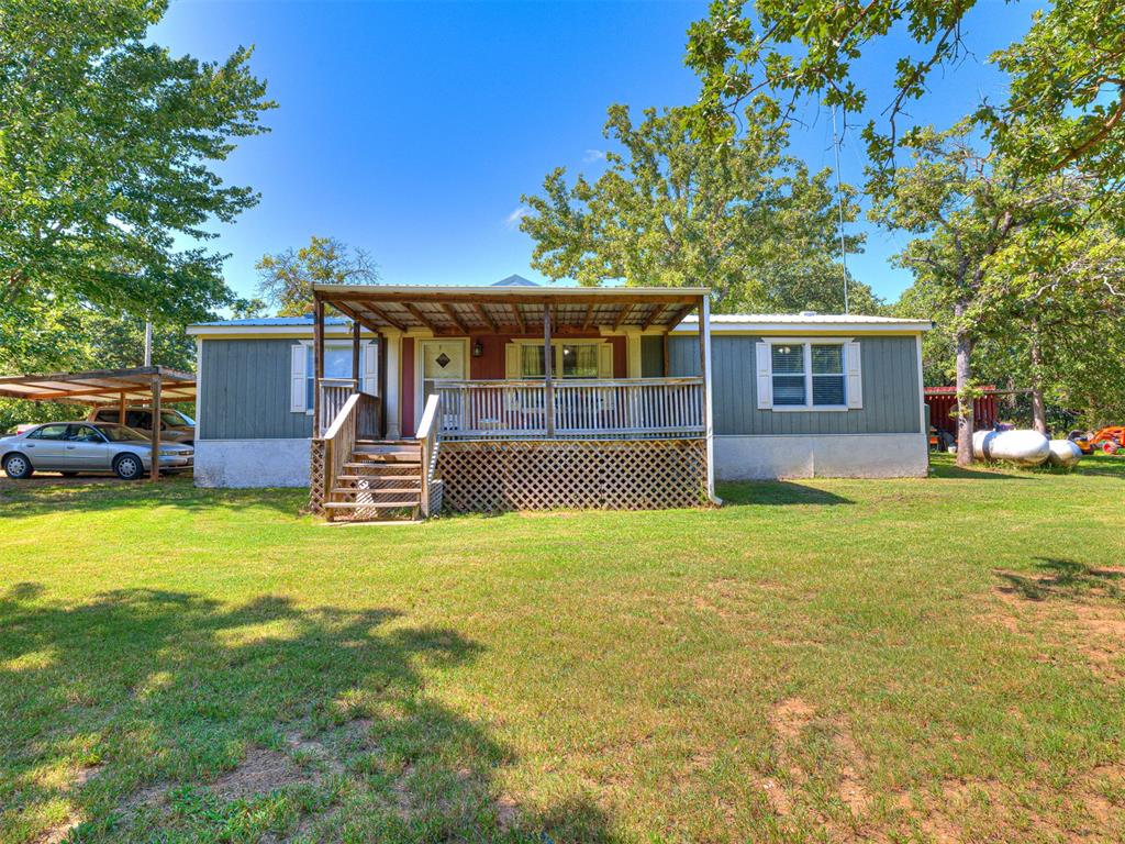 Elegant 3-Bedroom, 2-Bath Manufactured Home on just over 10 Acres.
Situated at the end of a well-maintained private road, this meticulously cared-for ranch style Oak Creek manufactured home offers three bedrooms and two bathrooms set on ten scenic acres. The property is heavily wooded and surrounded by mature oak, pecan, walnut, and hickory trees, providing a luxury outdoor tranquil environment. An electric gate ensures both privacy and security. The residence boasts high-quality drinking water and energy-efficient systems throughout. A picturesque creek with an established swimming hole enhances the property's natural appeal and peaceful atmosphere. Residents benefit from convenient access to Highway 9 and are located just one mile from Calypso Cove and 1.75 miles from the Lake Thunderbird dam entrance. This pristine home combines the advantages of rural living with modern comforts, including walk-in closets in each bedroom and propane hookups. Additional amenities include a covered porch, covered carport, underground storm shelter, and a 40-foot cube storage container. Don't miss this secluded, private, and heavily wooded acreage!