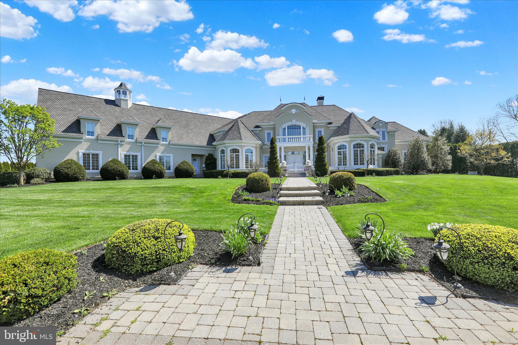 A Residence of Distinction in StonehengeSet with quiet authority on 1.45 acres within the exclusive Stonehenge enclave, 1000 Bluestone Drive stands as a masterwork of architectural refinement and enduring design. Inspired by the celebrated Scholz “Le Fontainebleu” plan and meticulously realized by master builder Galen Miller, this exceptional estate encompasses over 11,400 square feet of exquisitely finished living space, offering a rare synthesis of grandeur, craftsmanship, and livability.The arrival is both graceful and commanding. A grand foyer unfolds beneath a sweeping curved staircase, revealing a breathtaking interior where scale and proportion are perfectly balanced. The two-story formal living room, anchored by a stately fireplace and framed by expansive windows, is bathed in natural light—an elegant stage for both intimate moments and formal entertaining.At the heart of the residence lies a culinary masterpiece—a bespoke gourmet kitchen appointed with custom cabinetry, premium stainless appliances, and expansive granite surfaces. Seamlessly connected to the Great Room, this space invites gathering and conversation, with a fireplace and serene views across the private grounds and terrace. Nearby, the formal dining room, supported by a Butler’s pantry and generous walk-in pantry, is designed for hosting with ease and sophistication.The first-floor primary suite is a sanctuary of remarkable scale and comfort. A private fireplace, spa-inspired bath, and dual custom-designed walk-in wardrobes create an environment of understated luxury. A richly appointed office/study, also with fireplace, offers a refined retreat for work or reflection. Everyday functionality is elevated through a thoughtfully designed laundry suite and a discreet pet care room with integrated dog wash and kennel.A notable feature of the estate is the fully self-contained guest or in-law residence, complete with its own living room, kitchen, bedroom, bath, and laundry—offering privacy and independence for extended family or guests. The home has been further envisioned with long-term adaptability, including provisions for a future elevator installation.The second level continues the home’s commitment to comfort and privacy, offering two expansive en-suite bedrooms, each complemented by generous walk-in closets and refined finishes.Below, the lower level reveals over 4,300 square feet of impeccably finished space, curated for leisure and wellness. A recreation lounge, billiards area, private fitness studio, additional bedroom suite, and abundant storage create a complete lifestyle environment within the home.Outdoors, the estate unfolds into a resort-caliber setting, enhanced by extensive professionally designed, installed, and meticulously maintained landscape and hardscape. A striking saltwater pool with cascading waterfalls, sculptural gas-fired urns, and an expansive terrace create an atmosphere of serene elegance—equally suited to grand entertaining or quiet repose.Beyond its aesthetic excellence, the home is engineered for superior performance. A multi-zone geothermal HVAC system delivers energy-efficient, year-round comfort, complemented by gas-fired radiant in-floor heating. A 50-year architectural roof underscores the home’s enduring quality. The attached oversized  4-car garage  with  its 10'3" ceiling adds both convenience and functionality for the discerning owner.Perfectly positioned within the highly regarded Manheim Township School District, and moments from Bent Creek Country Club, the charm of downtown Lititz, Lancaster Airport, and the region’s finest dining and shopping, this residence offers a rare balance of privacy, accessibility, and prestige.Homes of this caliber are seldom offered. 1000 Bluestone Drive is not merely a residence—it is a statement of timeless elegance and inspired living. Schedule your private showing toda