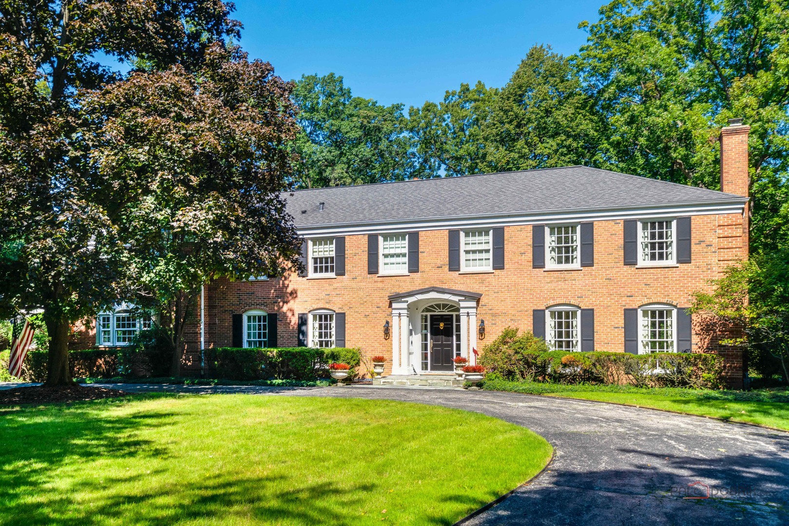 If you like seasonal views of Lake Michigan, combined with a dash of history, a stunning location and an exquisite home in the vibrant Village of Lake Bluff, look no further than 560 Lakeland Drive. Set on part of what was once the 30-acre "Lakelandwood" estate belonging to Stanley Field, this elegant red brick Georgian combines lovely traditional rooms (Living Room, Dining Room, and Library) with soaring open living spaces (Kitchen, Family Room and Sunroom) to create the best of all worlds for family living. Seasonal lake views can be seen from Living Room and Sunroom, especially, on first floor and from one second floor bedroom. Now on 1.38 acres, one home from the lake on a quiet cul de sac, the home features five bedrooms on the second floor, including the Primary, and a sixth bedroom on the first floor. There are 5 fireplaces (three with mantles from the original Field estate, two Laundry Rooms (1st and 2nd floors) and a second spacious Family Room on the second floor. Three bedrooms are ensuite; 2 bedrooms share a Jack & Jill Bath; and the 6th bedroom on the 1st floor has a bathroom next to it. There is a huge basement with a second kitchen, Rec Room, bath and tons of storage. There is a three car garage and numerous updates have been undertaken since 2013. You'll enjoy the spacious yard, with a patio, a firepit, and sweeping lawn areas overlooking a wooded ravine. The spectacular property is only a short distance from the vibrancy of downtown Lake Bluff, with its restaurants, concerts on the Village Green, Sunrise Beach, schools, Lake Bluff Golf Course, the Rec Center, and more! Even Lake Forest High School is only minutes away! Come discover how wonderful, fun and comfortable living here will be! Amenities & Features Sheet, plus Floorplans, are under Additional Documents.