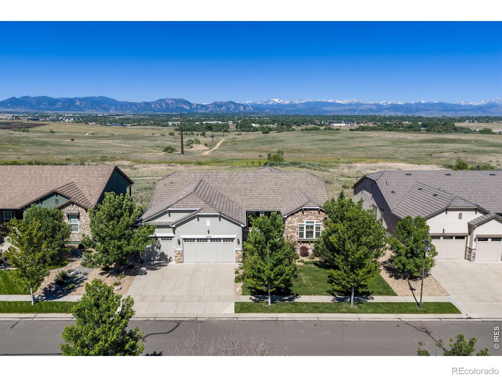 Enjoy breathtaking, uninterrupted views of the Front Range from this exceptional home. The gourmet kitchen features a 6-burner gas range, a new wall oven, and a new microwave. Even everyday tasks become extraordinary with stunning mountain views from the kitchen sink. The thoughtfully designed main floor layout has a bright, open floorplan. Cozy up to the gas fireplace in the living room. The spacious, main level primary suite has direct access to the deck, creating the perfect setting to enjoy Colorado's spectacular sunsets and mountain vistas. Anthem Ranch is a 55 plus community. The finished walkout basement offers outstanding flexibility, complete with a kitchenette, private bedroom, full bath, and an expansive recreation/family room. There are two unfinished storage areas also! Outdoor living is equally impressive with a partially covered west-facing deck featuring two retractable awnings, plus a lower-level patio with a gas fire pit for year-round enjoyment. A rare opportunity to enjoy luxurious living paired with some of the area's most spectacular mountain views.