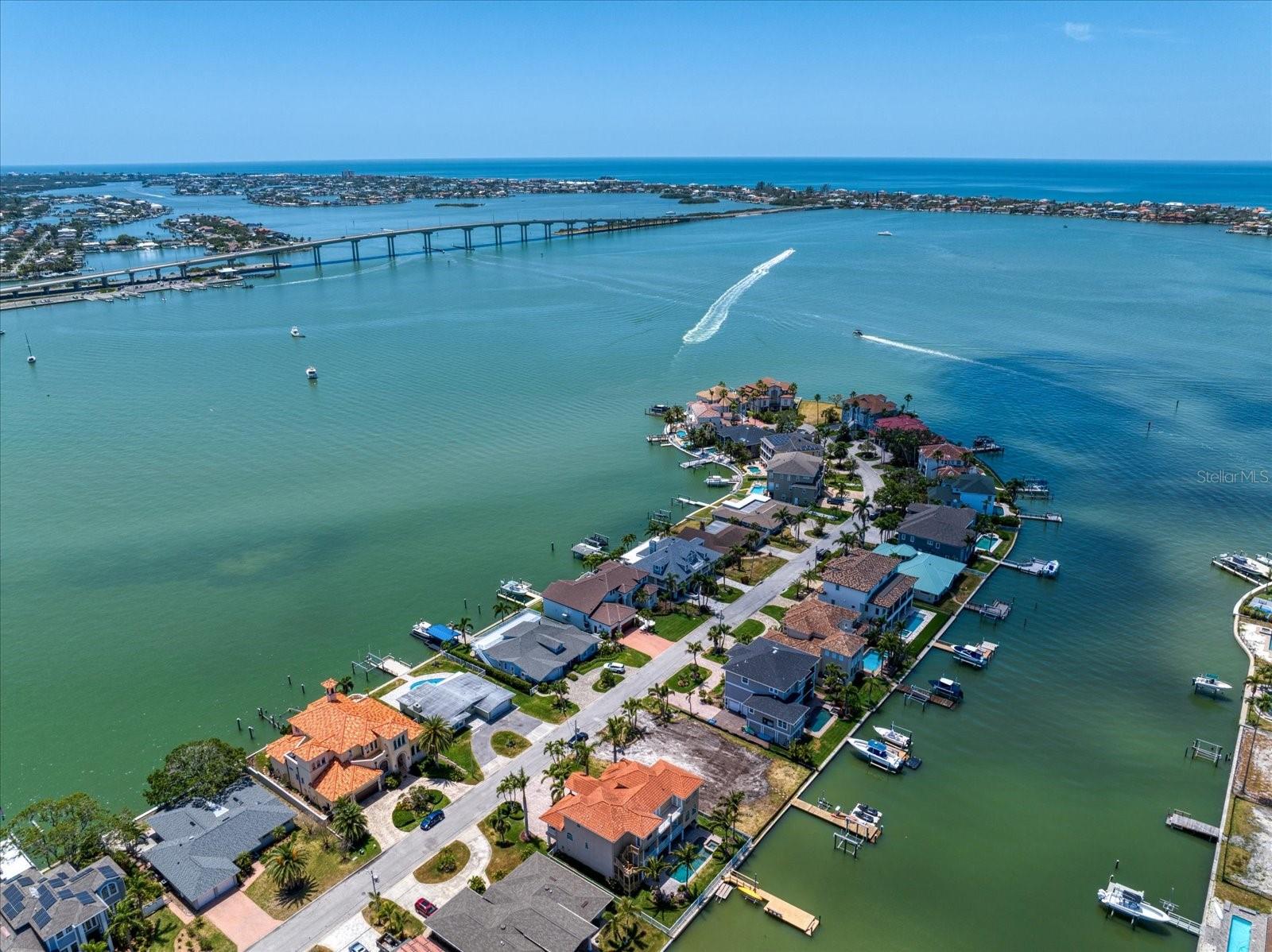 Prepare to be enchanted by the open-water views that greet you upon entering this magnificent residence. Just minutes away from the renowned Clearwater Beach, this stunning property promises an unparalleled lifestyle of luxury & comfort. Featuring 4 bedrooms, 3 bathrooms, & 2 half bathrooms, thoughtfully designed to offer both privacy & convenience. A dedicated office provides the perfect space for remote work. At the heart of the home lies an extraordinarily open floor plan, accentuated by floor-to-ceiling PGT impact-rated windows that invite the beauty of the outdoors in. The property is equipped with impact-rated exterior doors and a new ceramic tile roof. A full-house Generac generator ensures your comfort & security in any weather. For boat enthusiasts, the newly installed dock paired with a 13,000 lbs. boat lift allows for effortless access to the stunning waters of the Gulf. Conveniently located on the main floor, the primary bedroom serves as your personal retreat. Upstairs, an expansive living area provides additional space, perfect for hosting friends & family. Abundant built-in storage solutions throughout the home ensure that your living space remains clutter-free. The three-car garage caters to your vehicle and storage needs, while the home’s elevated design adds an element of safety and privacy. Notably, this property has sustained no hurricane damage during recent storms, underscoring its resilience and the quality of its construction. With Belleair Bluffs’ charming shops & restaurants just a short walk away, & the vibrant communities of Clearwater and St. Petersburg a quick drive, you’ll enjoy an array of dining & entertainment options at your leisure. Golf enthusiasts will revel in the proximity to three world-class golf courses designed by the legendary Donald Ross, all within five minutes of your new home. This meticulously maintained slice of paradise is not just a house; it’s a lifestyle waiting for you to embrace. Don’t miss your chance to call this remarkable waterfront residence your own. Schedule your private showing today!