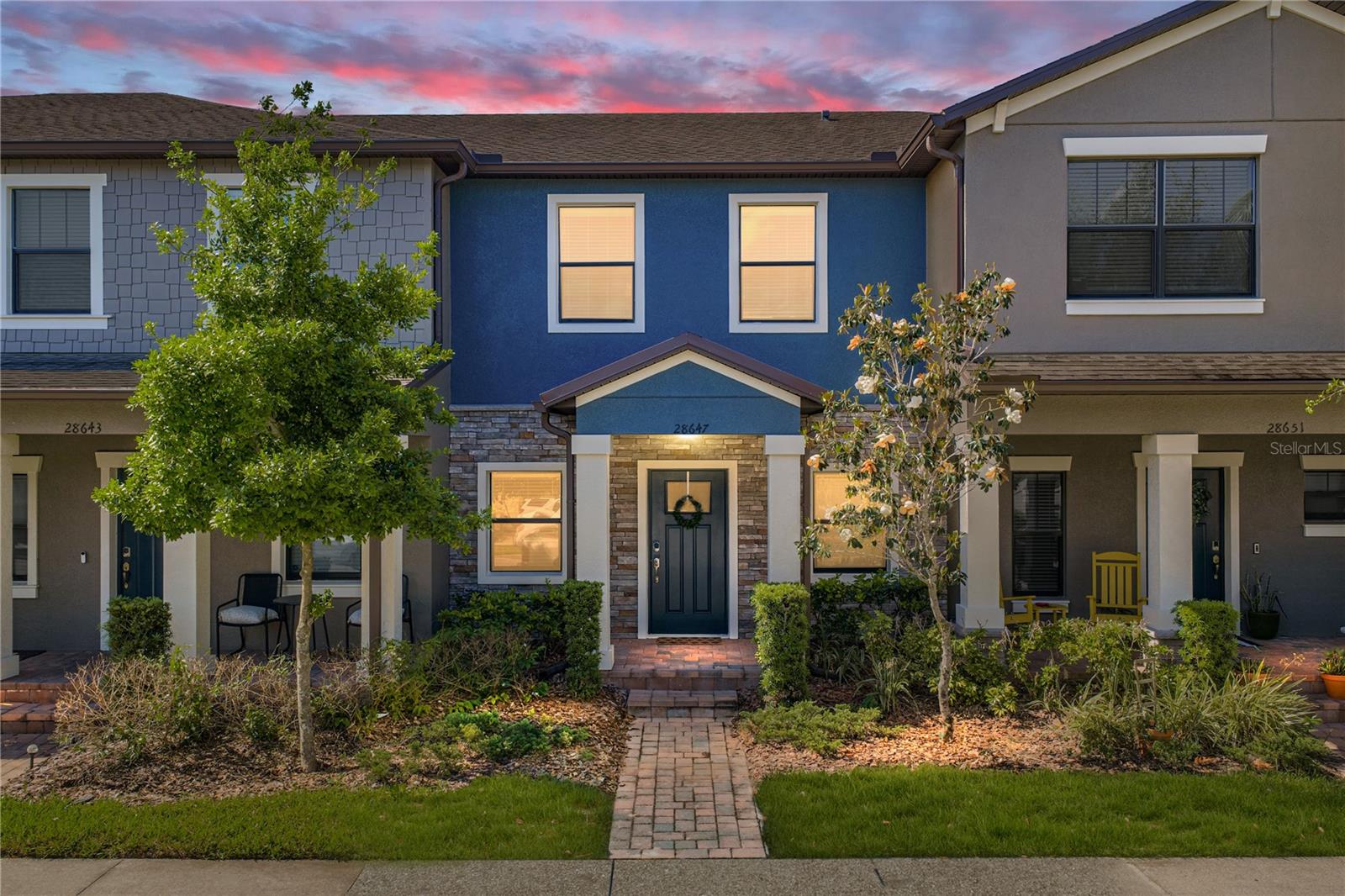 Stylish, spacious, and set within one of Wiregrass Ranch’s most desirable communities, this beautifully maintained townhome offers a polished, move-in ready feel with a layout that lives far beyond expectations! Arrive to a charming exterior where sidewalk-lined streets, lush landscaping, stone accents, and a paver walkway lead to a pillar-framed covered entryway that immediately feels welcoming. Built in 2017, this home stands apart with thoughtful design and an inviting presence from the moment you pull up. The first floor opens into an entertainer-friendly layout with tile flooring throughout and a natural flow from the living area to the kitchen and out to the private courtyard. A well-placed half bath for guests adds convenience without interrupting the flow. The kitchen is finished with granite countertops, wood cabinetry, breakfast bar seating, pendant lighting, and a stainless steel appliance package, creating a clean, updated look with plenty of room to gather and connect. Upstairs, a plush carpeted staircase leads to two generously sized bedrooms, each featuring its own ensuite bathroom, creating an ideal setup for guests, roommates, or flexible living arrangements. The primary suite stands out with a large walk-in closet and a dual sink vanity that adds a more elevated, comfortable feel to the daily routine. Out back, a covered and private courtyard sits between the home and the garage, complete with privacy fencing and a storage closet. It’s a cozy, tucked-away setting that feels like your own little retreat, perfect for quiet mornings or casual evenings outside. Life at the Arbors at Wiregrass Ranch is designed for ease, with HOA coverage that includes lawn maintenance and exterior pest control, along with access to a resort-style pool, dog park, walking trails, and additional amenities that enhance the overall lifestyle. Located in the heart of Wiregrass Ranch, this home places you just minutes from top-rated schools, shopping centers, restaurants, entertainment, and medical facilities, keeping everything you need close at hand. Call today to schedule your private showing and see what makes this townhome stand out!