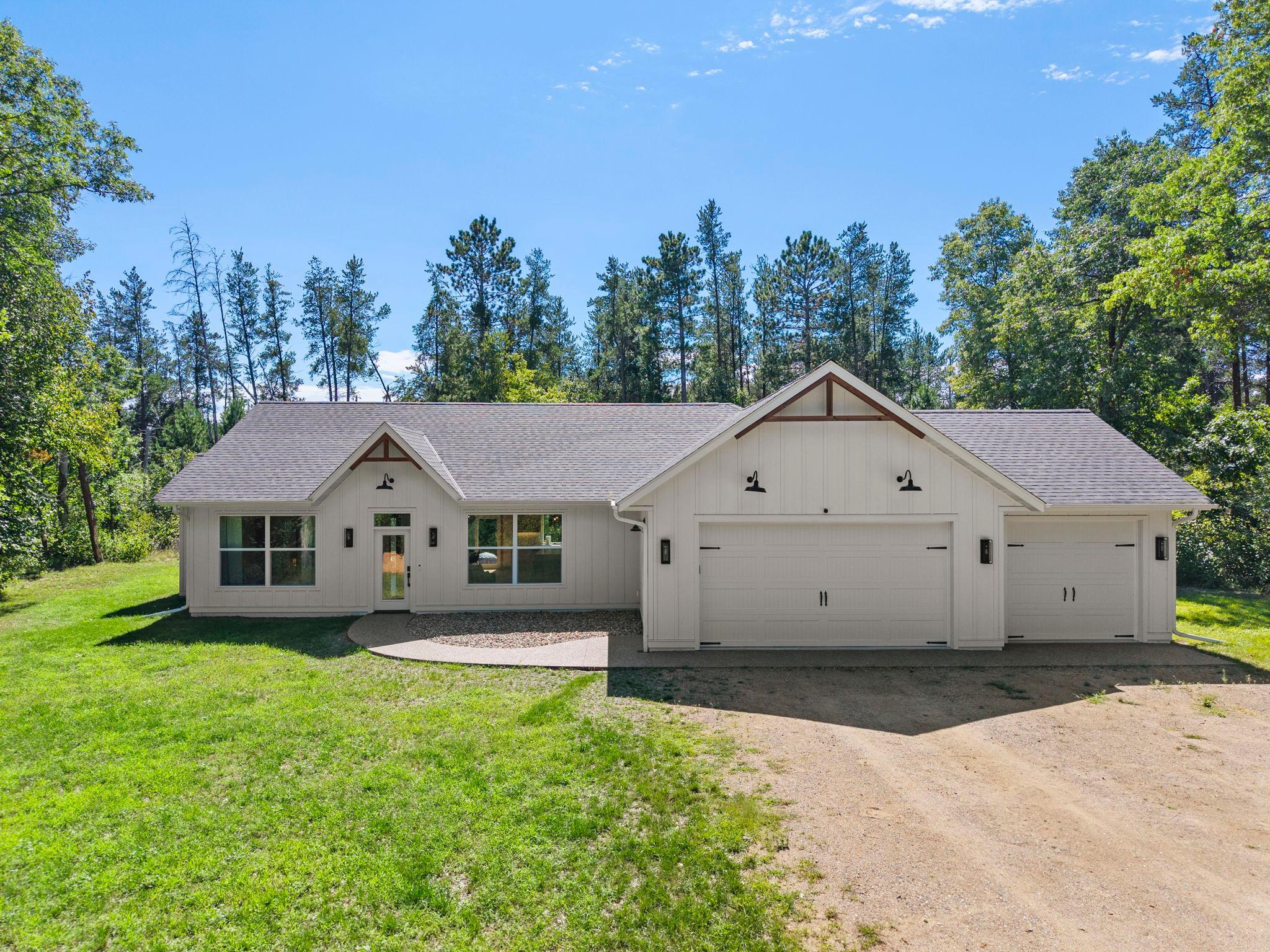 Enjoy easy one-level living in this beautifully updated three-bedroom, two-bathroom home tucked into the woods on a quiet, private road, just a mile from Highway 371 and minutes from Baxter's restaurants and shopping. The property sits 9 minutes from Gull Lake Recreation Area, 8 minutes from Cragun's Legacy Courses and Madden's Golf Course, and 4 minutes from Brainerd International Raceway, with fishing, boating, hiking, skiing, snowmobiling, and ice fishing all nearby. Whether used as a full-time residence, weekend cabin, or vacation getaway, the home is move-in ready.Inside, an open floor plan connects the living room, kitchen, and dining area. The living room centers on an electric fireplace, while the kitchen features an oversized island, walk-in pantry, backyard views from the sink, and stainless steel appliances. The dining area opens to a patio for outdoor meals. The primary suite includes a three-quarter en suite bath and walk-in closet. A mudroom with walk-in storage and laundry connects to the attached three-car garage. The washer and dryer were replaced in December 2024, and a water softener was added in 2025.Two additional bedrooms with spacious closets, one facing front and one facing back, share a full bathroom between them, ideal for family, guests, or a home office. The property comfortably sleeps six and includes an outdoor fire pit with seating.Currently operating as a successful Airbnb, the home can be sold furnished as a turnkey rental, offering the next owner an established income opportunity or a Northwoods retreat of their own.