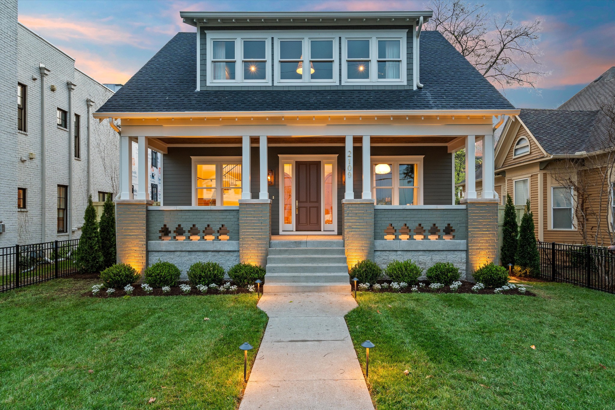 Maker delivers again—this time with an elite Hamptons-inspired new build that blends timeless elegance, thoughtful architecture, and modern livability. Thoughtfully designed by Feller Home Design and curated by Mitzi Maynard, this home reflects a level of scale and refinement rarely achieved, even in Nashville’s most sought-after neighborhoods. From the moment you enter, the feel is elevated yet grounded. A formal reception foyer leads to a parlor-style home office and richly layered living areas, each space designed with both beauty and function in mind. The kitchen is outfitted with a paneled column-style fridge and freezer, butler’s pantry, and smart integration into the great room—where natural light, custom textures, and thoughtful sightlines create an effortless flow. Maker’s signature touches abound: repurposed architectural doors, smart home wiring, Lutron lighting, and high-end finishes throughout. Indoor/outdoor living is seamless thanks to a pocketing glass wall, retractable screens, a full outdoor kitchen, and wood-burning fireplace—all under a sprawling screened-in porch. The lot itself stretches 40 feet deeper than the typical 12 South parcel, allowing for a truly expansive backyard with room for a future pool—an increasingly rare find this close to the action. Upstairs, the vaulted primary suite impresses with exposed decorative beams, a sanctuary-sized bath anchored by dramatic scale and elegant finishes, and a boutique-style dressing room. All secondary bedrooms are en suite and generously sized. A second-floor bonus room adds flexible living space, while the main level provides ample zones to entertain, work, or retreat. Moments from Sevier Park, the heart of 12 South, and just minutes to The Gulch and downtown, this location offers both walkability and quick access to the city’s best. Designer pedigree, meaningful scale, and refined livability—2109 10th Ave S is Nashville living in its most complete form.