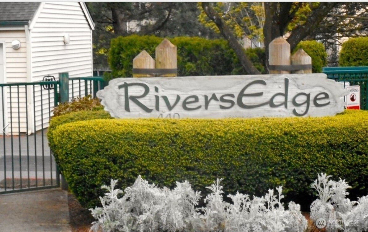 Welcome to Rivers Edge in Renton! This beautifully maintained main-floor condo offers 2 bedrooms and 2 bathrooms, combining comfort, convenience, and style in a secure, gated community with detached garage parking.Step inside to find spacious rooms with tall ceilings and an open-concept layout. The home features new carpet and wood flooring.  The generous primary suite includes a private patio—perfect for relaxing. The home also boasts a completely renovated main-floor walk-in shower with beautiful tile, adding a modern and luxurious touch.The kitchen is open and inviting, complete with stainless steel appliances and bar/dining seating, making it ideal for both everyday living and entertaining.Additional highlights include in-unit laundry, extra storage, and direct patio access from the living room.The community has been thoughtfully updated with no pending assessments—recent improvements include new roofs on both residential and parking structures, fresh asphalt throughout the complex, and an upgraded gated entry system.Move-in ready and ideally located—welcome home.