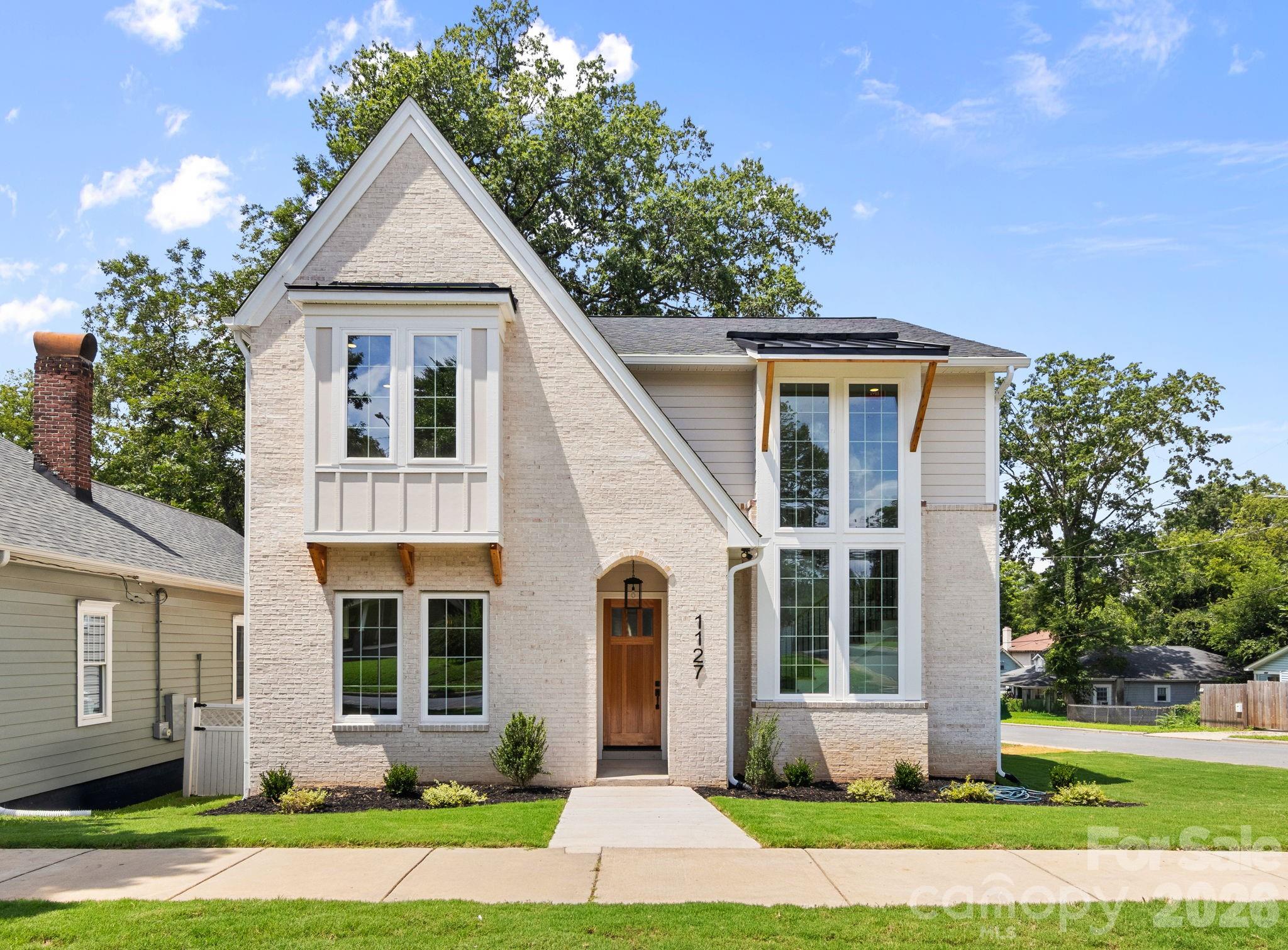 Luxury new construction meets timeless design in this stunning Belmont home, where thoughtful craftsmanship and high-end finishes shine throughout. Filled with natural light from oversized windows, the open-concept main level is designed for effortless entertaining, anchored by a beautiful fireplace and featuring gorgeous hardwood floors throughout the entire home. The designer kitchen seamlessly connects to the living and dining spaces, while the adjacent scullery provides exceptional prep space and additional storage—making hosting everything from intimate dinners to large gatherings a breeze. Completing the main level is a spacious dining room, covered rear porch, powder room, and a flexible guest suite with an en suite bath which could easily be used as an exceptional home office.  Upstairs, the luxurious primary suite is a true retreat with vaulted ceilings, a spa-inspired bath featuring a zero-entry shower, freestanding soaking tub, dual vanities, and an expansive custom walk-in closet. Two additional bedrooms each offer private en suite bathrooms, while the convenient upstairs laundry room adds everyday functionality. Every closet in the home is outfitted with custom built-in shelving and organization systems. Outside, enjoy a detached garage and a private backyard shaded by mature trees, offering just the right amount of outdoor space to relax, entertain, or play.  Located in one of Charlotte's fastest-growing neighborhoods, this exceptional home is just minutes from Uptown, Plaza Midwood, and neighborhood favorites like Ace No. 3 and Lew's BBQ, offering the perfect blend of luxury living and urban convenience.