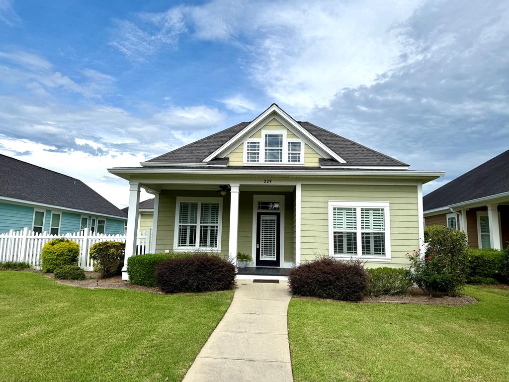 This well maintained 3 bedroom, 2 bathroom single floor home boasts a custom design with custom plantation shutters throughout. High ceilings, crown and millwork enhance the entire feel of the home. The common area features engineered hardwood floors, while the bedrooms are adorned with plush carpet. A spacious walk-in master closet provides ample storage, and the master bathroom boasts dual vanity sinks, a soaking tub, separate walk-in shower and water closet. Plus you'll never run out of hot water with the tankless water heater. The kitchen is equipped with an abundance of cabinets for storage, granite countertops, and a kitchen island that includes a vegetable washing sink. Stainless appliances complete the kitchen's features. The home also includes a sitting porch with a manicured picket fenced side lawn with irrigation and a hardiboard exterior for low maintenance living. Separate laundry room in the back mud room entrance. An oversized insulated and climate controlled garage provides room for your vehicle and additional storage space. Located in the popular Madison Grove subdivision, this home offers a variety of community amenities, including a clubhouse, pool, and gym. The nearby business section of Madison Grove features a hair salon, drink station, and other shops for convenience are within walking distance. Don't miss the opportunity to live in this desirable neighborhood. Give us a call today!