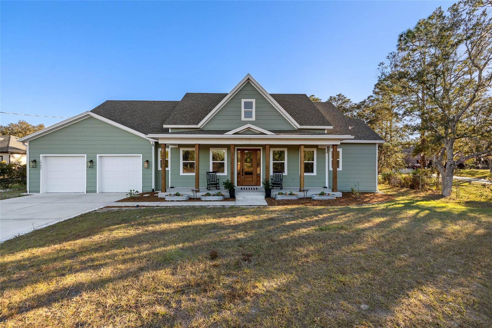 One or more photo(s) has been virtually staged. Discover serene, no-HOA country living on Orange County’s peaceful eastern edge—surrounded by nature and acreage, yet just 18 miles to Orlando International Airport (MCO), 31 miles to Walt Disney World and theme parks, 39 miles to Cocoa Beach, and 32 miles to Kennedy Space Center. Families love the top-rated schools: Wedgefield School (K-8) with an ‘A’ grade and 8/10 GreatSchools rating, plus East River High with a ‘B’ grade.Enter the bright foyer with high ceilings, leading to flex spaces: a spacious office/gym/bonus room on the left with fan, TV, and luxury vinyl flooring; a full guest bath on the right with vanity, shower, and luxury vinyl. The open-concept kitchen-great room features nearly new Samsung appliances (four-door fridge, built-in oven/microwave, cooktop, hood, dishwasher), granite counters, island seating, eat-in bar, formal dining for 10 with chandelier, wall-mounted TV, fan, luxury vinyl floors, 10-ft ceilings, 8-ft doors, and 13-ft sliders to a truss-covered back porch.This 5-bed, 4-full-bath, 2-half-bath home (expandable to 7 beds) has luxury vinyl flooring main areas (carpet in beds). The oversized primary suite includes dual vanities, standalone tub, double shower, tiled walls, water closet, 7x5-ft shower, 8x10-ft walk-in closet, fan, and TV. Additional bedrooms include king-sized potential, walk-ins, and Jack-and-Jill baths.Upstairs loft (potential 7th bed) has fan, half bath (room for full conversion), built-in shelving, and 225-sq-ft finished storage with wood floors and mechanical room. Luxuries include two full kitchens (main and in-law suite), two laundry rooms (main with Electrolux washer-dryer, counters, sink; suite with stacked unit and private heater), three extra wall-mounted TVs (total four), fans everywhere, and curtains on all windows. Furnishings negotiable outside price.The mother-in-law suite has private entry/patio, living room with two fans and TV, massive kitchen (20-ft counters, appliances, walk-in pantry), full laundry with storage/exit, oversized primary bed with carpet, fan, TV, en suite (dual vanities, handicap-accessible toilet/shower), and huge walk-in closet. Ideal for family, guests, or income.Outside: 8x32-ft front porch under truss, spacious back porch with fire pit, 751-sq-ft four-car garage with golf cart space, tandem parking, openers, epoxy floors, cabinets, scenic canal views, mature landscaping, and acreage for hobbies. Energy-efficient with insulating foam throughout for extreme savings, move-in ready with premium finishes—no HOA means freedom for families, or multi generational families near golf, shopping, attractions, and Hal Scott Preserve.Schedule your showing today—contact for details. Don’t miss this gem!MLS Embed Code: