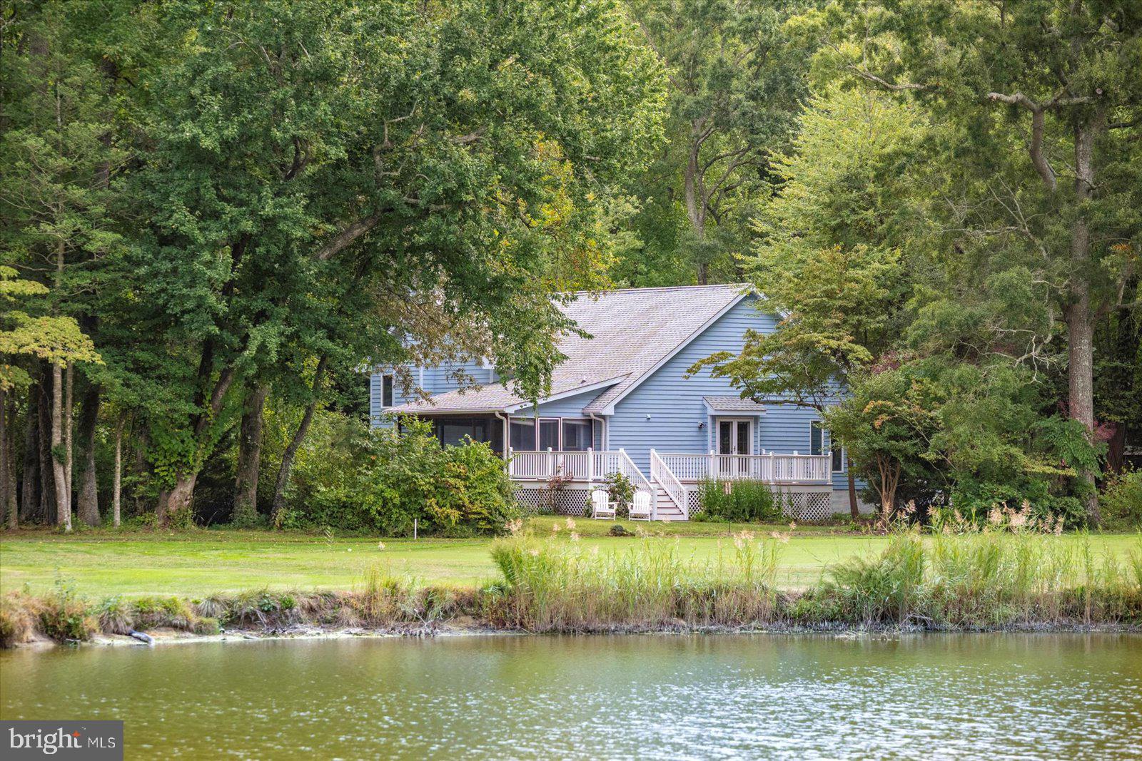 Welcome to 11410 Gaskin Dr, Berlin, MD — a spacious and serene retreat nestled on the Seaside Course at the Ocean City Golf & Yacht Club. Built in 1988, this freshly painted 2,852 sq ft home with new carpet offers 3 bedrooms, 3 full bathrooms, and a wonderful opportunity to make it your own. The main level features an oversized living room with beautiful hardwood floors and a bay window overlooking the golf course, a formal dining area with French doors that open to a large sundeck with sweeping fairway views, glimpses of the waters off Newport Bay, and stunning, picturesque sunsets. The eat-in kitchen features ceramic tile flooring, granite countertops, counter seating, and a sliding window that opens to the screened-in porch—perfect for enjoying the outdoors in comfort. From various points throughout the home, including the sundeck, screened porch, and rear yard, you'll enjoy tranquil pond views set along the golf course, adding to the peaceful, scenic atmosphere. Upstairs, the generous primary suite is highlighted by a dramatic arched window that provides golf course views and offers a timeless design element that fills the space with natural light, along with two additional bedrooms and a full hall bath with tub. The lower level includes a spacious second family room with fireplace, hardwood floors, sliding doors to a patio and gardens, a full bath, and a separate laundry room. The .67-acre yard is a tranquil, park-like sanctuary with mature trees, meandering paths, and visits from deer, blue herons, ducks, geese, and songbirds. Additional features include a two-car garage with dual doors and a bump-out workspace, plus a generator for added peace of mind. Located just minutes from Ocean City beaches, Assateague Island, public boat ramps, West Ocean City shopping and dining, and historic downtown Berlin, this home offers the perfect blend of comfort, nature, and coastal lifestyle.