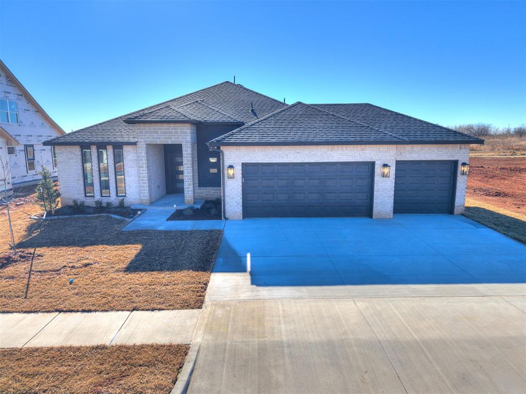 Step into luxury with The Woods Plan, a stunning home designed for both comfort and elegance. The spacious living area is bathed in natural light from expansive windows, highlighting a gorgeous fireplace and stylish wood-look tile that flows seamlessly throughout all common areas. The chef’s kitchen is a dream, boasting custom-built maple cabinets, sleek quartz countertops, stainless steel appliances, a direct vent hood, and striking pendant lighting, all complemented by a large walk-in pantry for effortless storage. Retreat to the private primary suite, where a spacious bedroom offers serenity and a walk-in closet with direct access to the laundry room for ultimate convenience. The spa-like primary bath is pure indulgence, featuring a free-standing soaking tub and a fully tiled, frameless glass shower for a true retreat experience. This thoughtfully designed split floor plan ensures privacy, with generously sized secondary bedrooms, ample closet space, and easy access to a stylish hall bath. A perfectly placed pocket office makes working from home a breeze! Enjoy the outdoors on the charming covered front porch or relax on the expansive covered back patio, perfect for entertaining or unwinding. The oversized 3-car garage provides extra space, and included blinds throughout add the finishing touch. This home comes complete with 2" blinds and a tankless water heater!