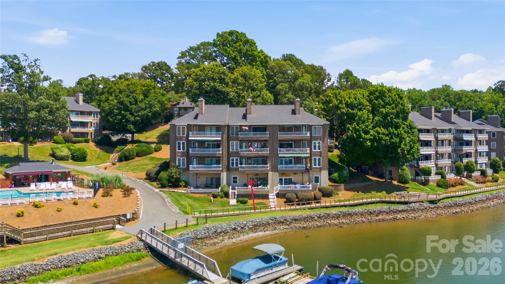 You can be on the lake enjoying the summer; rarely does an opportunity like this come along! This exceptional waterfront condo on Lake Wylie offers breathtaking lake views from nearly every room and is thoughtfully appointed with state-of-the-art smart-home technology, featuring voice-activated controls throughout. Relax with spectacular sunset views from both the upper and lower lakeside decks, creating the perfect setting for entertaining or unwinding. The chef-inspired kitchen is equipped with a Frigidaire Gallery range with Air Fry, newer stainless steel appliances, expansive granite countertops, a wet bar, luxury vinyl plank flooring, and abundant workspace. The inviting living room is anchored by a dramatic floor-to-ceiling slate fireplace flanked by custom built-in shelving. Retreat to the luxurious primary suite, where the spa-inspired bath features an Ariel steam shower with a jetted soaking tub for the ultimate in relaxation. The lower level offers a spacious guest bedroom with a private bath and versatile bonus room, with sliding glass doors opening to the expanded deck and waterfront views. Completing this incredible offering is highly desirable Boat Slip #59, making it effortless to enjoy boating, fishing, and all that Lake Wylie has to offer. Don't miss your chance to embrace the ultimate lakefront lifestyle.