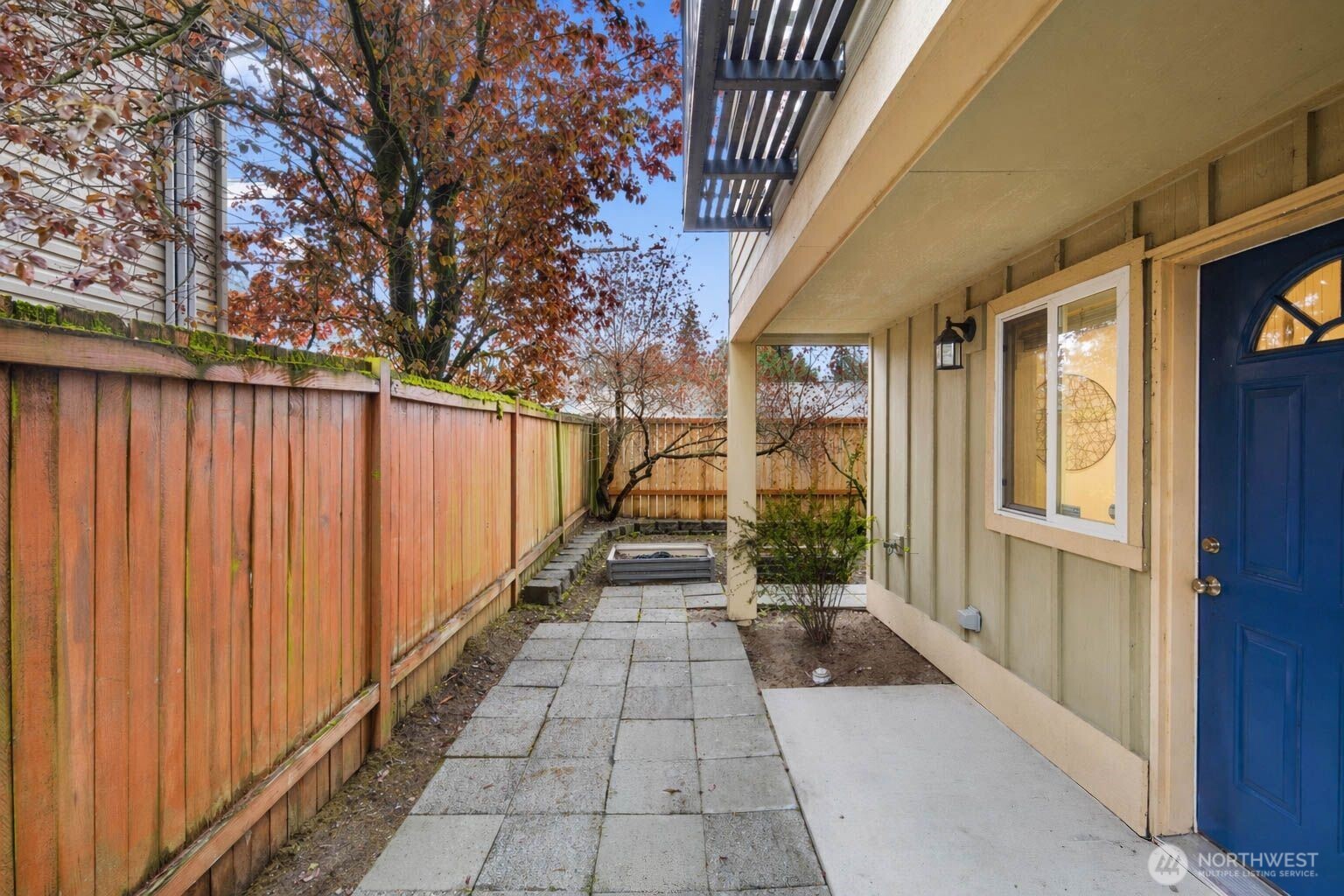 You can have it all with this turn-key townhome in Greenwood! 3 spaced out bedrooms with their own bathrooms, a double vanity primary suite, a functional backyard, dedicated parking, no HOA, PLUS a separate lower level entrance for aspirational house-hackers. Turn-key move in ready w/ ample additional parking available. 3-unit community with no HOA. Close proximity to the Northgate Lightrail and RapidRide transit. A wider-than-typical layout, tall ceilings, and open spaces create an airy, comfortable flow you don’t often find in Seattle townhomes. The entry level includes a flex bedroom / office with a full bath and its own separate back entrance—ideal for guests, work-from-home, or house-hack potential! Through the entry level you'll find a large, secluded, fully-fenced yard with code-secured access. The second level has hardwood floors throughout the light filled open concept living, kitchen, and dining spaces. Conveniently located half bath off the living area. The kitchen has a deep 1-piece sink, a gas range, bar seating, plenty of storage, modern appliances, and great prep space for daily living or hosting. On the 3rd and final level, you'll find the primary suite with a double vanity en-suite bathroom and strong natural light shaded between the mature landscaping and Juliet balcony. Fresh interior paint and new carpet make it truly move-in ready. Easy commute to Downtown, the Eastside, and all Seattle has to offer. Property is pre-inspected and comes with a warranty!