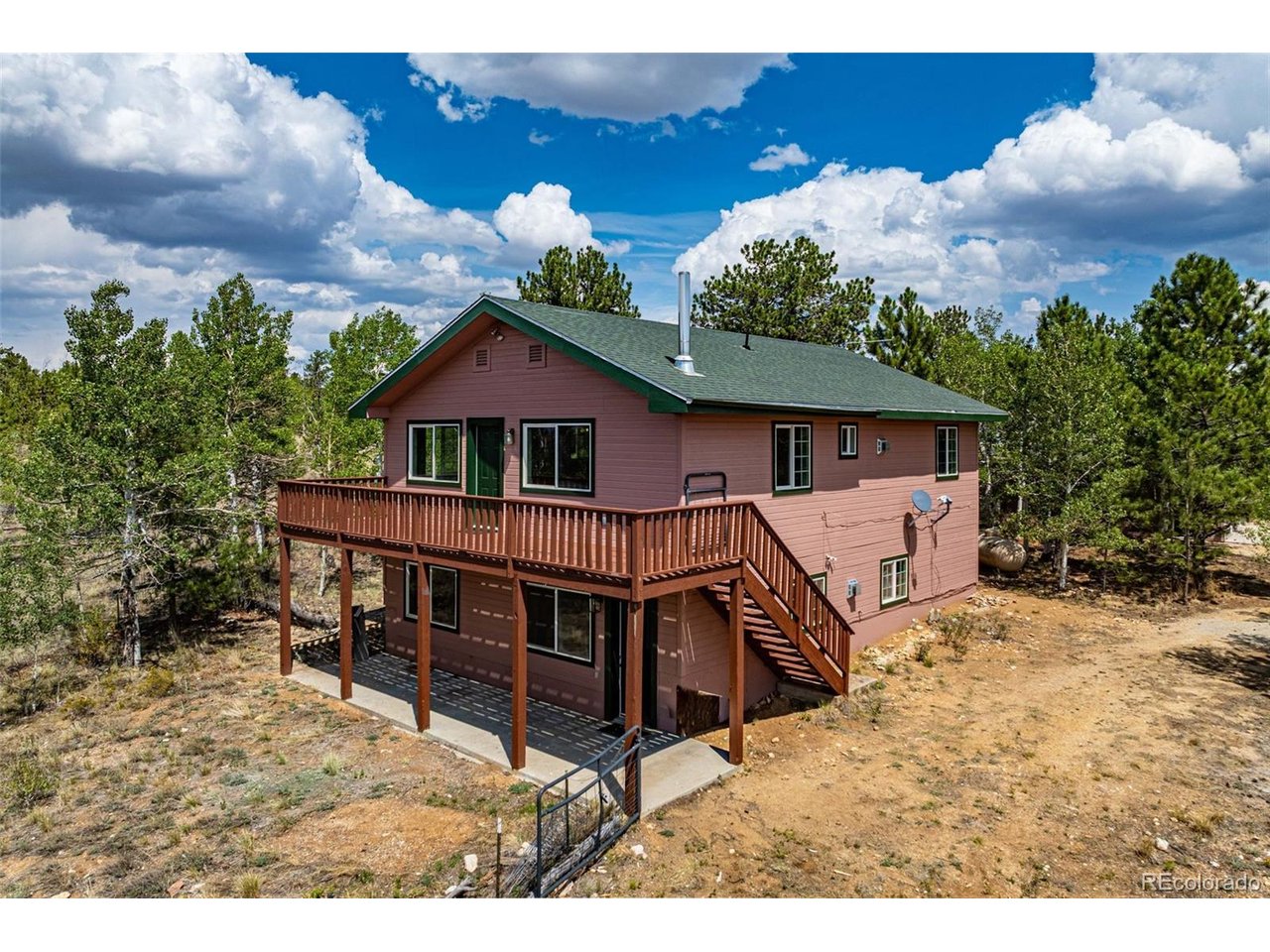 Escape to the heart of the Rockies in this wonderful 3-bedroom, 2.5-bathroom home located in the peaceful, expansivelandscapes of Hartsel, Colorado. Perfect as a primary mountain residence or a part time getaway, this property perfectlybalances rugged mountain charm with modern comforts. The home sits on 4.38 acres and offers amazing views of theRockies and many Colorado 14ers from the generous deck. The main level features 2 bedrooms, a full bathroom, generouslaundry room and comfortable living space. Upstairs you'll find an open floor plan with the kitchen, dining and living areasall combined for entertaining or family time. There is also a guest powder room and the large primary bedroom offers agenerous bathroom with soaking tub. Enjoy morning coffee or starry nights on the expansive deck.