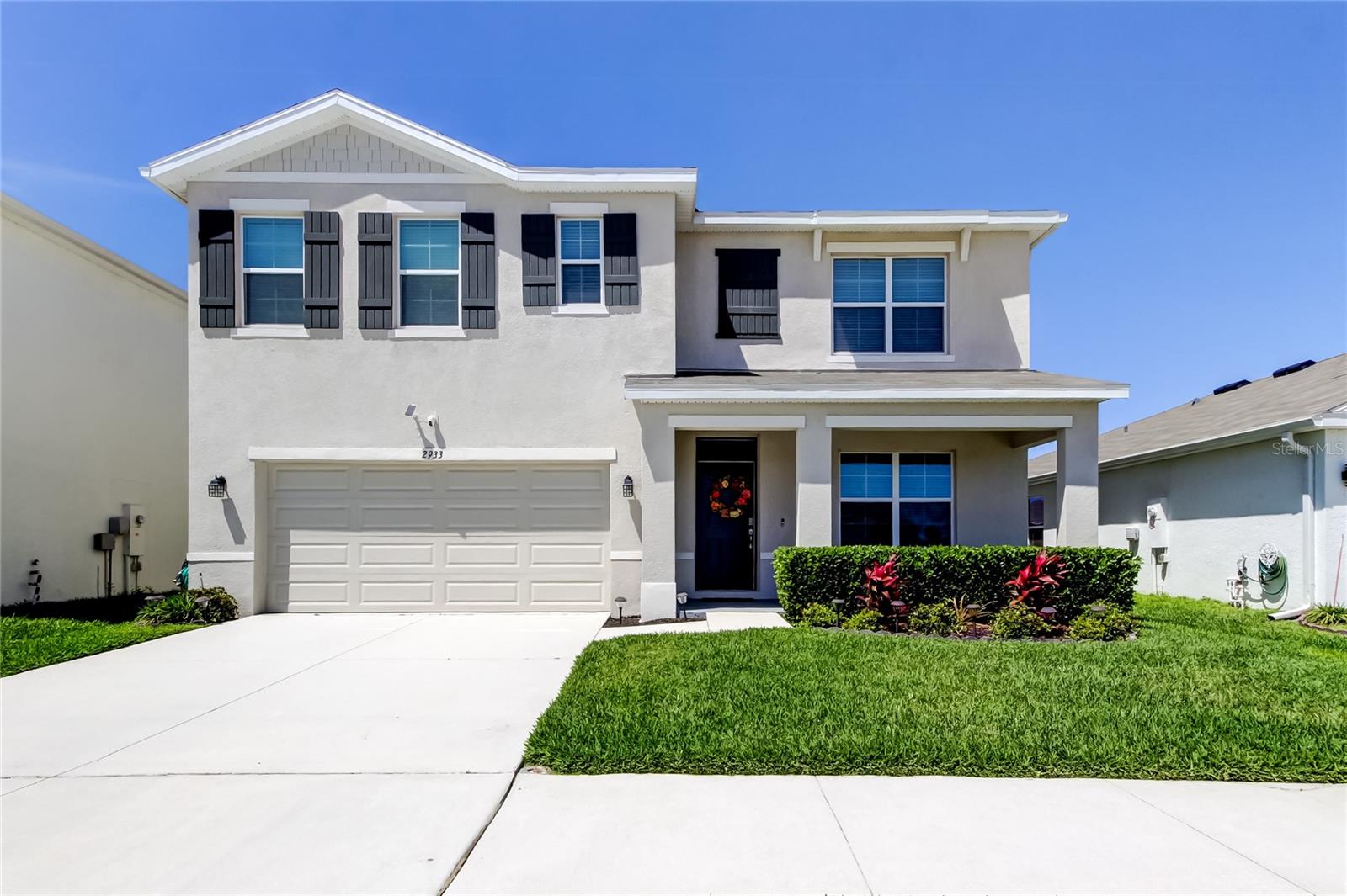Welcome to 2933 Maiden Grass Isle, a beautifully maintained 2022 DR Horton “Hayden” model located in the highly desirable, completed Summerstone community of Wesley Chapel. Offering 2,605 square feet of thoughtfully designed living space, this move-in ready home truly stands out. Situated on a rare 50-foot homesite — the only one of its kind in the community (builder error turned buyer advantage).This spacious floor plan features 5 bedrooms, 3 full bathrooms, a dedicated flex/office space, and an upstairs bonus room with closet. The open-concept main level is ideal for both everyday living and entertaining, with a seamless kitchen and living room combination. The chef’s kitchen showcases stainless steel appliances, granite countertops, abundant cabinetry, a large pantry, and a generous center island.A first-floor bedroom and full bath provide flexibility for guests or multi-generational living. Upstairs, the expansive primary suite offers dual walk-in closets, dual vanities, and a walk-in shower. The conveniently located second-floor laundry room sits adjacent to the primary suite. All secondary bedrooms are generously sized with ample closet space.Additional highlights include: Fully fenced backyard, Homesite directly across from community open field, Smart home technology package,  Ring doorbell camera, In-home LCD monitor with thermostat control and messaging center, Motion-activated backyard security lighting, First-floor glass break sensors, Alarm system on all upstairs windows, and the garage is pre-wired for Bluetooth security camera. Owner upgrades include: Fence installation, Kitchen sink fixture upgrade, Custom pantry shelving, Primary closet shelving, Irrigation system upgrade, and an upgraded stove.  Residents of Summerstone enjoy resort-style amenities including a community pool, open-air pavilion with kitchen, shaded tot lot, open playfield, and half basketball court. Conveniently located near State Road 56 and Morris Bridge Road, with easy access to top-rated schools, Wiregrass Mall, dining, shopping, and entertainment.  This exceptional home offers space, smart features, and an unbeatable location — a rare opportunity in one of Wesley Chapel’s most sought-after communities. Schedule your private showing today.
