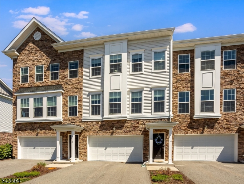 Experience luxury living in this stunning townhome, built in 2020, featuring 3 bedrooms and 3.5 baths.  Ideally situated near both Morris Plains and the Morristown train station, enjoy a seamless commute to NYC while savoring the tranquility of suburban life. With a wealth of amenities within walking distance including supermarkets, delightful dining options, and even a Starbucks this location truly offers the best of both worlds. Step inside to an open concept living and dining area that boasts a spacious layout, adorned with elegant hardwood floors throughout the main level. The well-equipped kitchen, complete with a stylish island, is perfect for casual gatherings and entertaining. Convenience is key with a laundry area located on the second floor, simplifying your daily routines. Each of the three bedrooms provides ample space, including a generous primary suite that features a custom walk-in closet, ensuring both comfort and versatility for your lifestyle. The ground level is designed for entertainment, featuring a roomy family room and a full bathroom that flows effortlessly into a private backyard. Enjoy the added benefits of a 2-car garage, complete with extra storage and a wide driveway for additional parking options. Don't miss this opportunity to own a modern townhome where luxury meets convenience! Come and see for yourself how this beautiful home can enrich your lifestyle!