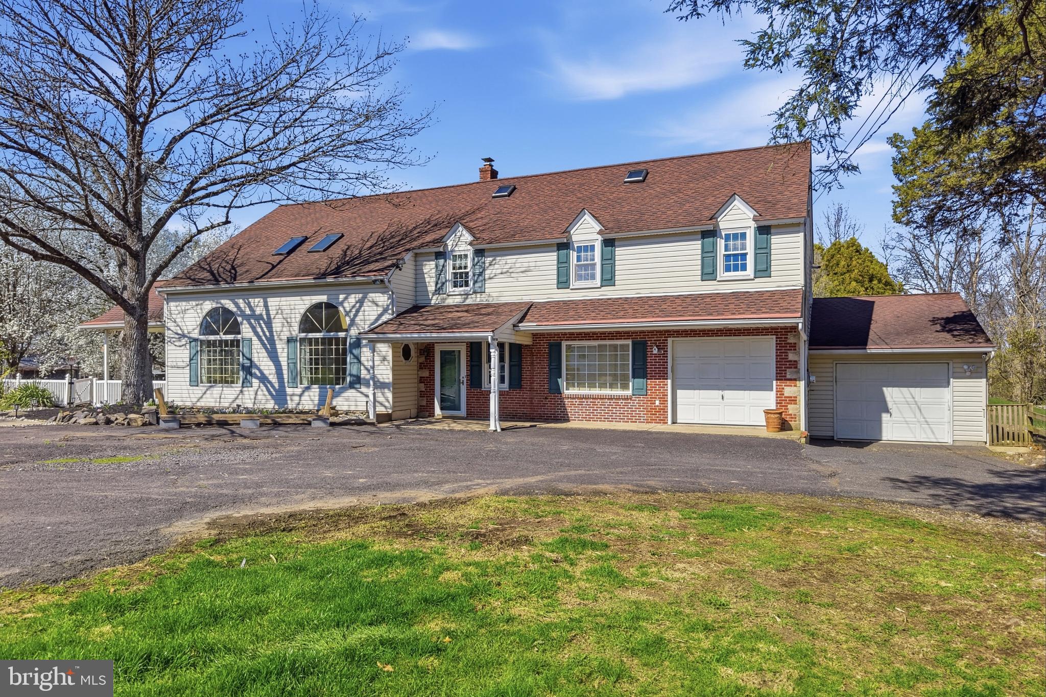Your dream home has, finally, hit the market! Welcome home to 1920 Ridge Rd in Telford, PA! This almost 4,000 square foot home provides the opportunity to easily add an in-law suite or to run a home based business out of the main level without disrupting your family. Sitting on 2.71 acres of land and with multiple out buildings (with potential for you to add a pole barn) this home is the perfect blend of rural escape and close to everything for the family who loves hosting large family or company gatherings or simply entertaining indoors and outdoors! Add in the bonuses of: a finished basement with a large bar, 2 fireplaces (one wood and one propane), cathedral ceilings, massive family and dining rooms, a covered porch, and a large composite deck and this is one home you will not want to miss! As you drive in, you’re greeted by the expansive lot that is almost fully fenced, the flowering trees, and a welcoming front porch. The main level features a lovely foyer opening to a massive living room / dining room with cathedral ceilings, skylights, a balcony overlook, large custom windows with arched tops and sliding door access to your covered patio with ceiling fan. Your spacious eat-in kitchen features ceramic tile floors, oak cabinets, quartz counters, a pass through to the dining room, tons of counter space and an over sink window box overlooking your expansive yard. The family room virtually mirrors the living / dining room in features with: cathedral ceilings, skylights, a wood burning stove insert, new carpeting and large windows to give you a wonderful view out back. Off of the family room is an enclosed porch with beautiful windows and 3 sliding glass doors to your composite deck. The enclosed porch features: ceramic tile floors, wood ceilings and a propane fireplace (tank has been removed). Rounding out the main level you will find two powder rooms, a laundry room (with laundry chute), an additional space that could be an: office, in-law suite, play room, home gym, craft room and more. The 2 one car garages are heated and there is a multi-purpose room off of the upper garage! Upstairs you will find 2 wonderful bedrooms on your right both with H/W floors under new carpet. There is also a hall bath with a tub shower on this end of the house. At the top of the stairs is a hall space with a cutout view down into the foyer that is the shape of the property and walk up stairs to the attic spaces. Check out the view from the balconies  to the LR / DR or to your beautiful family room! Your primary bedroom with new carpeting has cathedral ceilings, a ceiling fan and a huge en-suite bath with soaking tub, stall shower, cathedral ceiling and a very large vanity. From the primary BR you have access to the back balcony overlooking the family room and a bonus room with commanding views of your property that also has a ton of potential! The closet space with cabinetry & laundry chute could also be converted into a 4th bedroom. The floored attic space has 2 large spaces with paneled walls plus built-in drawers and eve storage & could become an additional bedroom or office space. Your finished basement has a large glass block bar, a smaller back kitchenette area, a built-in smoke eater, stairs to outside, and an additional crawl space that houses your oil tank and mechanicals.  Outside you will find that all out buildings have electric run to them and that there is a large garage space for outdoor equipment, a cabin with a wood burning stove, a hand pumped well, and a root cellar. There is a chicken coop building, a one horse barn with an attached building, a stage style structure and finally a screened gazebo. Septic system is a raised sand mound installed in 2011. Most of the house is of 2x6 construction with R-19 insulation in walls and R-30 in ceiling. Owners are selling the property in its present condition with no credits or repairs. Showings start at the open house on Thursday 4/9/26 at 4pm.