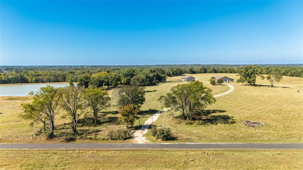 Over 70' elevation changes in this very diversified Ranch and Hunting Property and with over 228 ag exempt acres! Starting on the front of this unique property with custom *FULLY FURNISHED* BARNDO that contains very nice custom spacious living quarters and offers a bonus of 2 additional sleeping quarters with a bathroom & shower  upstairs. Also, a 2nd furnished sitting area (with bar, TV  & shuffleboard table) in the shop for entertaining and enjoyment, the remainder of the shop has 3-12' rollup doors and plenty of space for RV parking, equipment or great working area. There are covered porches to sit and relax looking over a 4 acre lake (covered pier) and over 50 acres of improved meadows surrounding the house with scattered Oaks and rolling hills, a 40x40 custom built horse stable with 3 priefert stalls, horse runs, wash rack, tack room and a  bathroom provide a first class horse facility. There is another barn near the front that offers a place for hay and equipment storage. This area is fenced and cross fenced.  The middle section of this property offers rolling hardwood, cedar and natural growth that has several scattered openings that are good for some additional grazing or the perfect place for food plots and wildlife management area. There are several seasonal natural water spots that would make some great managed duck sloughs. The back of the property is a hunters paradise with Greenwood Creek and Big Creek crossing the property and providing some of the best hunting in East Texas. This property is one that covers it all from weekend getaway, hunting property, livestock facility, corporate retreat, recreational use or the future site of that new custom home. Located only 1 mile from I30 (with good roads), only 17 miles from Sulphur Springs, 5 miles from Mt Vernon and only 90 min. from DFW area provides quick and easy access to this great retreat. Property is bordered by larger ranches to minimize the encroachment and provide privacy while hunting & enjoying