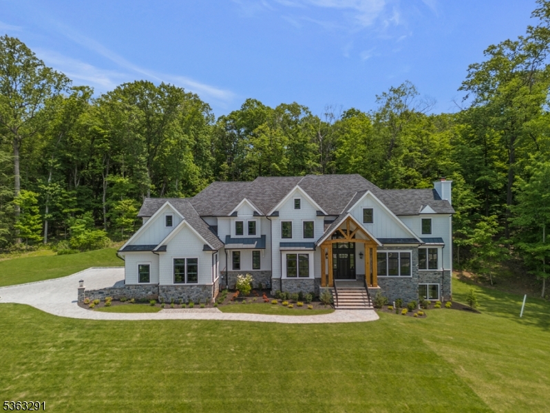 Welcome to Sleepy Hollow at Warren, a premier new construction home by CRC Communities set atop a knoll at the end of a peaceful cul-de-sac. This home offers both privacy and commanding views in one of Warren Township's most sought-after neighborhoods. This stunning residence offers over 3 acres of private, open and wooded property, combining luxury, privacy, and superior craftsmanship with commanding views in a tranquil setting.Inside, the home features 5 spacious bedrooms, 5 full bathrooms,1 half bath.  Hardwood floors flow throughout accompanied by high ceilings that enhance the sense of space and natural light. The grand foyer welcomes you into a thoughtfully designed interior with elegant finishes and open-concept living spaces. The gourmet kitchen is the heart of the home, featuring top-of-the-line appliances, custom cabinetry, and a large center island, ideal for both entertaining and everyday living. Adjacent is the breakfast room which has direct access to a covered patio, perfect for outdoor dining and relaxation.The main level also includes a formal library with a fireplace, providing a quiet retreat for work or study, as well as a large family room with a second fireplace, creating a warm, inviting atmosphere. Upstairs, the luxurious primary suite with a double door entry is a private sanctuary complete with its own fireplace, spa-like bath, and expansive walk-in closets. Each additional ensuite bedroom ensures comfort and privacy for all.