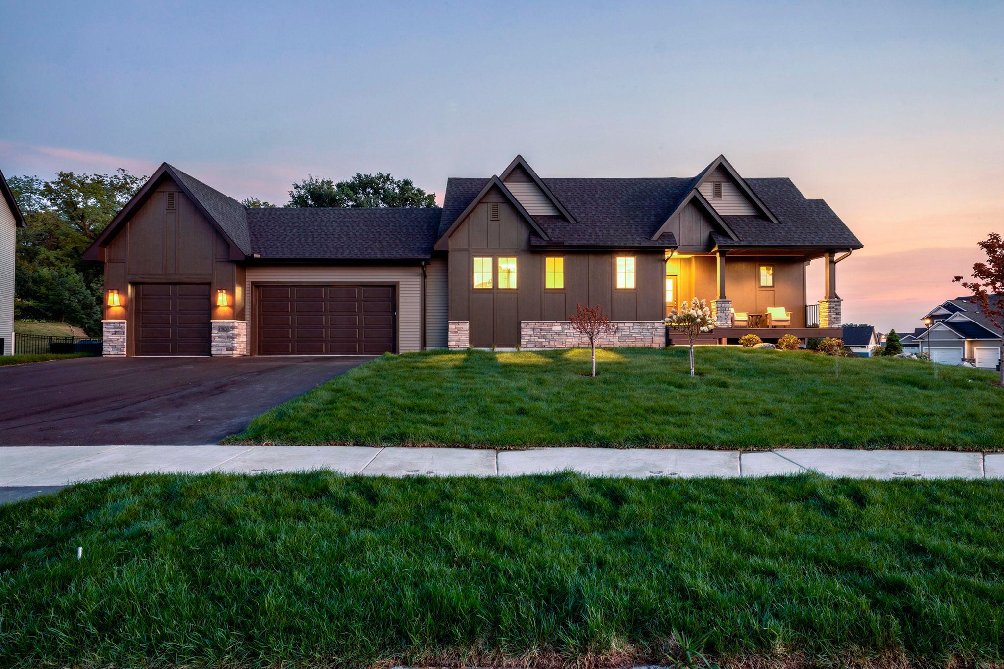 Experience refined single-level living in this beautifully designed one-story home offering an open-concept layout. The kitchen impresses with a large center island, quartz countertops, tile backsplash, custom soft-close cabinetry, and a spacious walk-in pantry. The adjacent dining area offers seamless access to the backyard patio. The great room showcases soaring 13’ vaulted ceilings, expansive Andersen windows, white oak engineered hardwood floors, and a cozy gas fireplace, creating a warm and elegant gathering space filled with natural light. The main level features a luxurious owner’s suite with a private 3/4 bath including a beautifully tiled walk-in shower and a generous walk-in closet. A versatile second bedroom and full bath and laundry room complete the main floor. The finished lower level expands your living space with a sun-filled family room and spacious recreation area, ideal for a game room, gym, or media space. A stylish wet bar with full-size refrigerator enhances entertaining, while two additional bedrooms and a 3/4 bath provide excellent accommodations for guests. A TimberTech maintenance-free front porch and desirable corner lot provide inviting curb appeal and added privacy. Additional highlights include an attached 3-car garage, functional mudroom, and in-ground irrigation system. Thoughtfully designed, this home delivers exceptional style, space, and everyday livability.