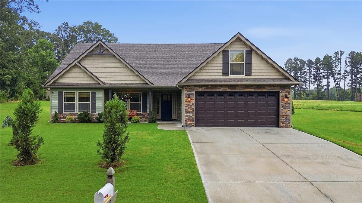 Like new and impeccably maintained, this beautiful 4-bedroom home sits on a private, peaceful 1-acre homesite offering the perfect blend of comfort and country living. No HOA! From the moment you arrive, you'll appreciate the manicured landscaping, exceptional curb appeal, and meticulous attention to detail throughout.  Inside, the open-concept floor plan features luxury vinyl plank flooring, granite countertops, and upgraded Craftsman-style interior trim that creates a timeless, custom feel. The spacious kitchen flows seamlessly into the living and dining areas, making it ideal for both everyday living and entertaining. Custom Roman shades add style and function throughout the home.  The generously sized primary suite and three additional bedrooms provide flexibility for family, guests, or a home office.  Step outside to enjoy the quiet surroundings, expansive yard, and the privacy that only a country setting can offer. A storage building provides additional space for tools and equipment.  Refrigerator, washer, and dryer all convey, making this home truly move-in ready. The sellers are also including numerous additional items, including a lawn mower, outdoor furniture, and other accessories—an exceptional value that allows you to start enjoying your new home from day one.  If you're looking for a home that shows like new, offers quality finishes, and provides peace, privacy, and convenience, this is one you won't want to miss. Street view photo (if shown on syndicated websites) is out dated and prior to construction of home.