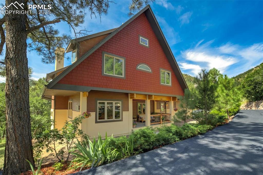 Experience life in Colorado in an extraordinary manner.  This very special property offers over 2 acres in the woods with a babbling creek you can hear from your primary suite.  It was built by a local builder Tom Day with the renderings of artist Sarah Susanka, author, architect and visionary.  Some unique features include milled alder trim and doors, custom tile work, bamboo flooring, custom glass transoms..... and then add a gourmet kitchen with large island, slab granite, updated appliances, custom birch cabinets and large walk-in pantry.   Family gatherings are easy with its "open" concept to include the butler's pantry, large dining room and large island, along with a cozy fireplace nearby.   The bonus suite with its separate entrance works well for overnight guests or long term family visits.  The mechanics of this home include radiant hot water heat, on-demand hot water, whole house fan, whole house speaker system, and spearate hardwired internet for each bedroom.  You will appreciate a wet bar with sink and small refrigerator in the basement, an office OR bedroom on the main level, many wonderful built-ins and central vac with 3 hoses. 
It cannot be stressed enough the uniqueness of the beautiful custom woodwork and diversity in products used for the interior design.  The closeness to nature is unparalled. Walk down the road to Palmer Lake Reservoir trailhead for a daily hike or walk 5 minutes to town for a morning coffee or venture down to the creek at the base of your property to find your very own private sitting area for reading, comtemplating life or a nap!  The driveway has been newly resealed with ample parking in the back (up to 14 cars), stucco was refreshed and painted, and new privacy fencing installed.  There are many possibilities here -raise your family in the woods in a small town, make it an escape from the big city, or it has been very successfully used as a short term rental if that is something you desire.