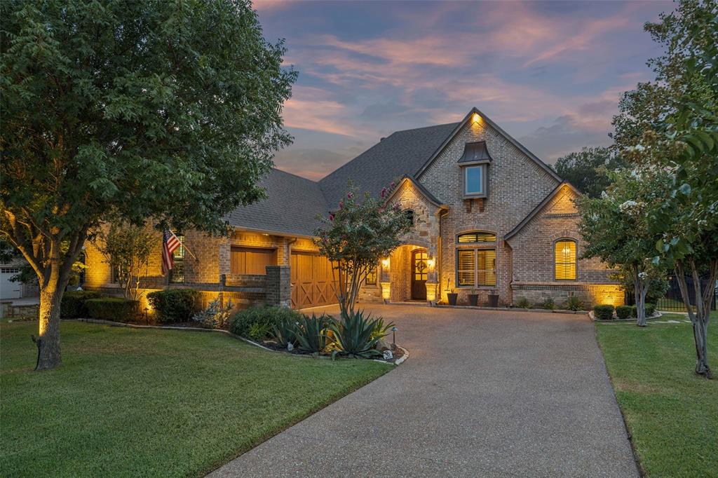 Welcome to this stunning 4-bed, 3-bath, single-story home in The Resort, a 24-hour gated and guarded golf course community on Eagle Mountain Lake. Boasting a rare split-bedroom floorplan, a 3-car garage, and a backyard oasis overlooking the pool and golf course, this exceptional home offers the perfect blend of luxury, comfort, and resort-style living. The expansive living room showcases a floor-to-ceiling stone fireplace, custom interior window shutters, automatic shades, and large windows that frame breathtaking backyard and golf course views. The living area flows seamlessly into the beautifully remodeled kitchen, featuring stunning granite countertops carried up the backsplash, a large island, double ovens, a 5-burner gas range, a new Vinotemp wine refrigerator with beverage bar. The oversized primary suite is a private retreat, complete with backyard access and an en-suite bath featuring a walk-in shower, soaking tub, and dual vanities. A custom walk-in closet connects directly to the laundry room, featuring new quartz countertops. Three bedrooms and two full bathrooms with new quartz countertops complete the thoughtfully designed interior. Updates include two new HVAC units in 2025, new roof and gutters in September 2024, and all new windows replaced in July 2026 with a lifetime transferable warranty.  Step outside to your own backyard paradise, the oversized outdoor living area features two fireplaces and overlooks the pool, complete with a large tanning ledge and water features. A custom-fitted pool cover, newly installed turf, and new outdoor lighting enhance the backyard's beauty, functionality, and ease of maintenance. Enjoy Resort amenities including an 18-hole golf course, clubhouse restaurant and bar, two pools, fitness center, pickleball courts, playground, community boat ramp, and boat slips. This meticulously updated home offers an unparalleled opportunity to enjoy luxury living with true resort-style amenities, all in one exceptional setting.