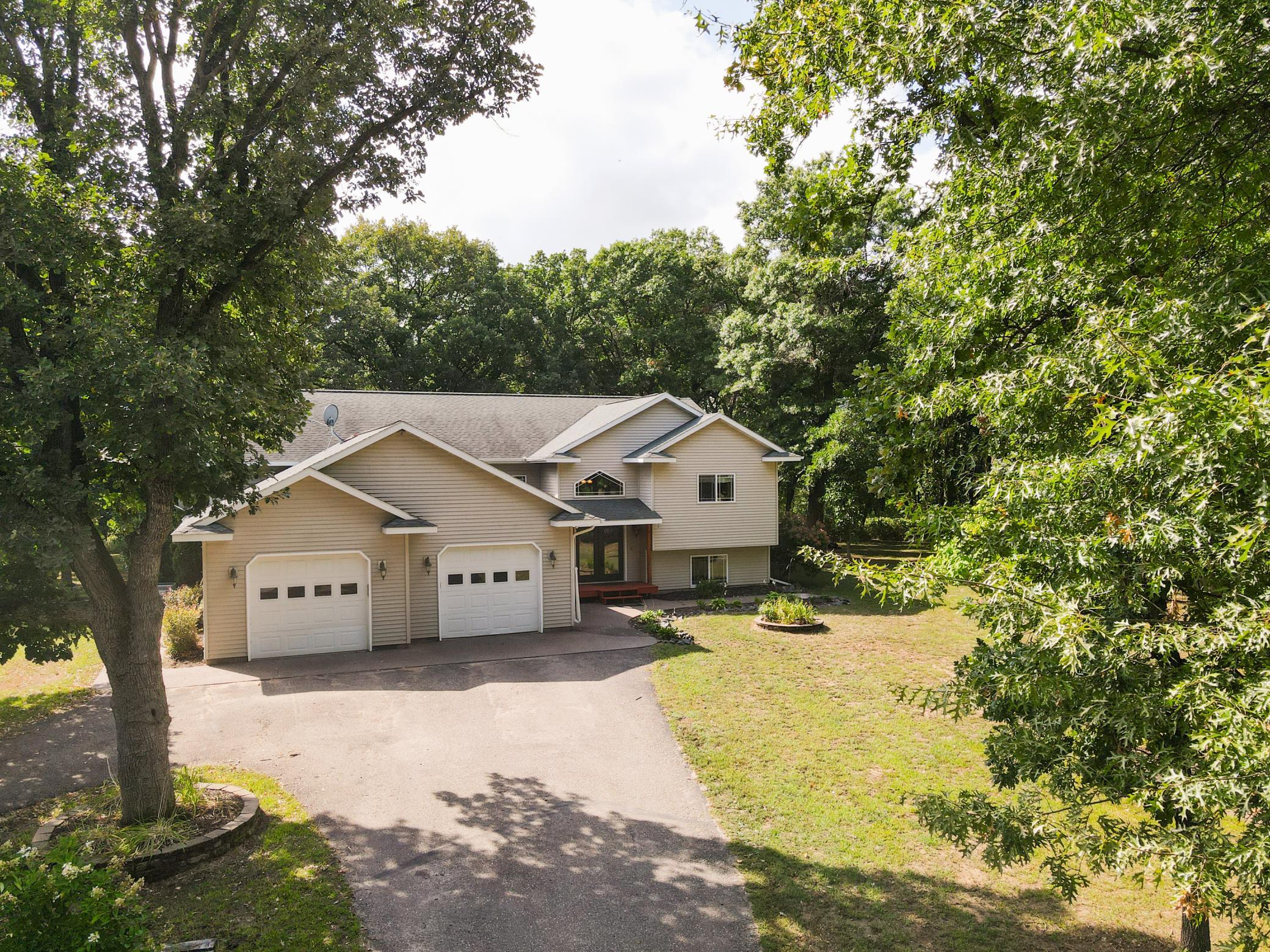 Welcome to this exceptional custom-designed 4+ bedroom, 3-bath home set on 7 beautiful acres just south of Little Falls. Thoughtfully designed with quality craftsmanship and impressive attention to detail, this spacious property offers comfort, style, and plenty of room to enjoy country living. The heart of the home is the stunning gourmet kitchen, featuring rich Alder cabinetry, a large center island with breakfast bar, wall oven, and an abundance of large windows that fill the space with natural light. The gorgeous primary suite showcases a dramatic tray ceiling and a luxurious ensuite bath, complemented by a large walk-in closet. Every bedroom is generously sized and offers oversized closets, while solid doors throughout the home add to its quality and timeless appeal. Step outside onto the expansive multi-level deck—an ideal setting for entertaining, relaxing, or taking in the peaceful acreage.The finished lower level is designed for both recreation and entertaining, featuring beautiful travertine tile flooring, wiring for surround sound, and plumbing already in place for a wet bar. And there’s more! A separate building/guest house has been finished to the same high standards as the main home, offering incredible flexibility for guests, extended family, a home office, hobby space, or additional living accommodations. This one-of-a-kind property combines custom craftsmanship, spacious living areas, exceptional entertaining spaces, and the privacy of 7 acres—all conveniently located just south of Little Falls.