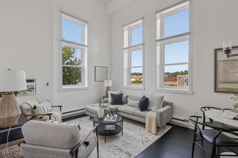 Stunning Renovated 2BR/2BA Corner Condo in Prime Westfield Location! Beautifully updated unit with southern exposure and abundant natural light through brand-new triple-paned windows. Features include a fully renovated kitchen with quartz countertops and backsplash, new stainless steel appliances, soaring ceilings, hardwood floors, and brand-new in-unit washer/dryer and AC units. The spacious bedrooms and two modern full baths offer comfort and functionality. Less than a block to the train and steps to downtown shops, restaurants, and more. Building/HOA amenities include: water, sewer fees, garage parking + bike storage, elevator, secure entry with intercom system entry, in-building trash disposal, generator backup for hallway lighting, lawn area for lounging and snow removal & maintenance. This move-in ready condo is ideally located for the best of in-town Westfield living!