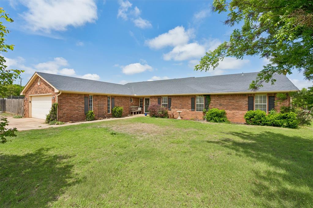 Set on a beautifully quiet 1-acre, this spacious and character-rich home offers room to live, work, and entertain with ease. Featuring 4 bedrooms and 2.5 baths, the layout is both functional and inviting, ideal for hosting guests or enjoying everyday living. A welcoming entryway opens into a lovely step-down living room with elevated ceilings, canned lighting, and gas log fireplace with a handsome wood mantle, built-ins and cabinetry add both charm and functionality. The kitchen is thoughtfully designed with quartz countertops, a built-in glass-top stove with hood vent, oven, microwave, vibrant Mexican Talavera tile backsplash, and plenty of cabinet space. Just off the kitchen is a well-appointed laundry room featuring cabinets, a countertop, sink, space for a second refrigerator, and a convenient half bath. A large dining room filled with natural light creates an inviting space for gatherings. The private office, complete with French doors, wood paneling, tile flooring, making it an ideal workspace. The spacious master suite offers a raised ceiling, crown molding, and a walk-in closet with built-ins. The en-suite bathroom includes a double vanity with mirror cabinets, a Jacuzzi tub, and separate shower. Additional features include a large concrete basement/storm shelter, painted concrete flooring in select areas, security windows, unique light fixtures, and ceiling fans in every room. The home also boasts new carpet, a 2019 high-impact roof, and updated HVAC(American Standard heat pump) replaced in 2019. A NEW Rheem water heater installed in 2026 adds to the home’s efficiency. The outdoor amenities further enhance the property, including a chicken coop, a 20x22 barn with power line already run (not yet connected), electric fencing for dogs, and four gated entry points. With the added advantage of an assumable 3.25% loan, this home offers a rare combination of peaceful space, versatility, and unique character, making it a standout opportunity.