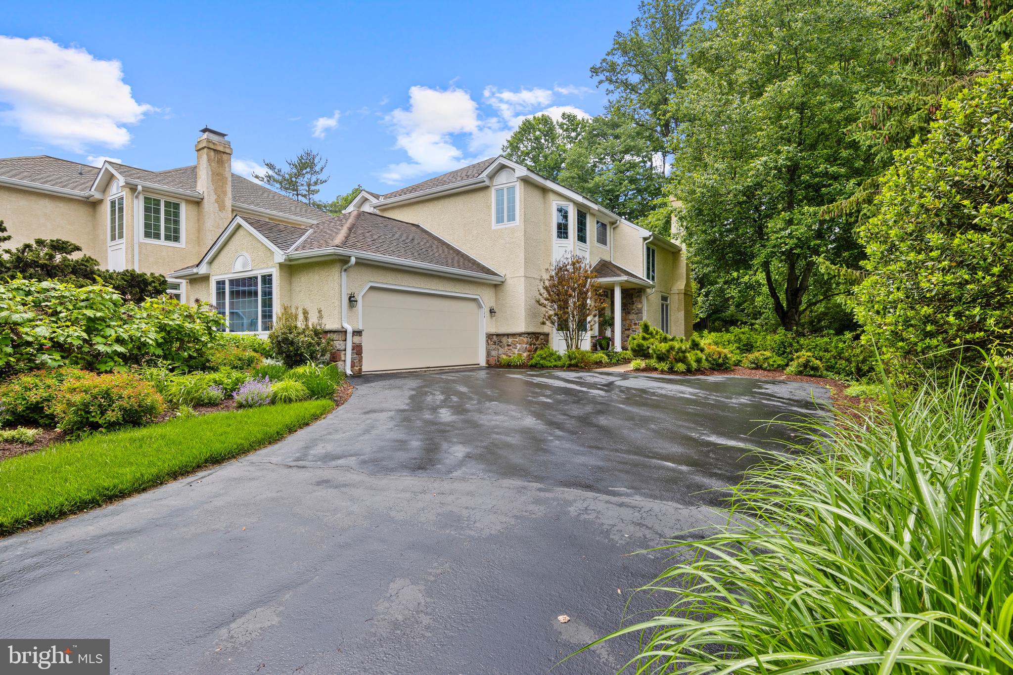 Beautifully situated on a quiet cul-de-sac in the highly sought-after community of Waynesborough Woods, this impeccably maintained two-story end-unit carriage home offers one of the most private settings in the neighborhood. Set back from the street and backing to open space, the home combines exceptional privacy with elegant indoor and outdoor living. For added peace of mind, the sellers completed full stucco remediation and replaced all windows and doors in 2021. Thoughtfully updated throughout, the home features a gorgeous stone patio and newer composite deck, creating inviting outdoor spaces ideal for relaxing or entertaining. A dramatic two-story foyer welcomes you inside and immediately showcases the home’s sense of openness, warmth, and refined design. Sunlight fills the thoughtfully designed interior, highlighting exceptional craftsmanship and attention to detail throughout. Fireplaces in both the living room and family room create warm, inviting focal points for everyday living and entertaining. Designed to balance open-concept living with defined gathering spaces, the home offers elegant formal living and dining rooms with exquisite trim work and gleaming hardwood floors. The spacious family room features a stunning stone fireplace and direct access to the private rear patio. At the heart of the home is the expansive kitchen, complete with generous workspace, a sunny breakfast area, and seamless access to the rear deck. Open to the family room, this space is perfectly suited for both everyday living and entertaining. Additional main-level highlights include a first-floor laundry room, powder room, and attached two-car garage. Upstairs, the serene primary suite offers a private retreat, complete with ample closet space and a beautifully appointed en-suite bath. Two additional spacious bedrooms and a beautifully renovated hall bath provide comfortable accommodations for family and guests alike. The finished lower level adds exceptional versatility to the home, featuring a generously sized recreation room and abundant storage space—perfect for a media room, fitness area, playroom, or flexible living space to suit your needs. Ideally located in the heart of Berwyn, this home offers convenient access to everything the Main Line lifestyle has to offer. The nearby Paoli Train Station provides direct service to Center City Philadelphia and Amtrak connections to New York City, while major commuter routes including I-476, the Schuylkill Expressway, the Pennsylvania Turnpike, and Route 1 make travel effortless. Enjoy world-class shopping and dining just minutes away at King of Prussia Town Center and Ellis Preserve, along with the charming boutiques, restaurants, and everyday conveniences that make Main Line living so desirable. Plus you can enjoy the maintenance free living that makes it easy to lock and leave as the HOA covers, lawn and garden care, snow removal and common area maintenance. Showings start Wed., August 12th.