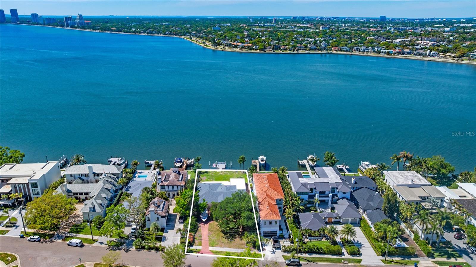 RARE OPEN BAYFRONT OPPORTUNITY – LAND VALUE ONLY. A premier chance to build your custom waterfront estate on Tampa’s coveted Davis Islands. Situated on an expansive 18,392 SF lot (88x209), this exceptional open bay property offers 88 feet of direct waterfront with full western exposure and stunning sunset views across the bay toward iconic Bayshore Boulevard. This property provides a unique opportunity to create a true blank canvas for redevelopment. A brand-new seawall and 2025 dock are already in place, featuring two lifts, one for a boat and one accommodating two jet skis, setting the stage for a spectacular new build designed to capture breathtaking sunsets, unobstructed open water vistas, and the refined coastal lifestyle Davis Islands is known for. The lot’s rare width and extraordinary depth create endless architectural possibilities, design a sprawling modern estate, elevate for commanding views, incorporate expansive glass, and maximize seamless indoor outdoor living. Ideally positioned near the entrance of Davis Islands for convenient access on and off the island, and just minutes from Downtown Tampa, Water Street, the Riverwalk, Tampa General Hospital, and A-rated schools, Davis Islands offers an unmatched island lifestyle complete with a yacht club, marina, tennis complex, community pool, waterfront parks, and a charming village of local shops and dining. This is a rare opportunity to secure a prime open bay homesite and design a one of a kind waterfront residence tailored to your vision. Open water. New seawall. Exceptional potential.
