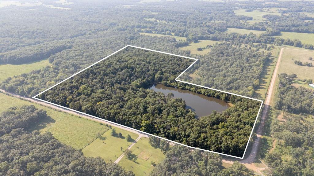 Just a few miles off of Highway 54, you will find this peaceful getaway in Saint Clair County. Turning off the county road that borders the property, you immediately step into a setting that demands hamburgers, sweet tea, fishing poles, and some classic country music. A 2 bedroom, 1 bath cabin sits at the end of a 2.5 acre pond stocked with bluegill, bass, and crappie that are just waiting for you to try your luck. The porch is the best seat in the house for watching the sunrise, fish surfacing, or the deer grazing around the pond.The garden shed is a great place for UTV’s, lawnmowers, and deer stands out of the elements and locked up tight. The timber around the pond is loaded with deer, and in the spring you can hear long beards looking for hens in the area. If you have been looking for a quiet getaway for the weekend, a hunting ground for the family, or a quiet build site for a new home-this is your spot.
