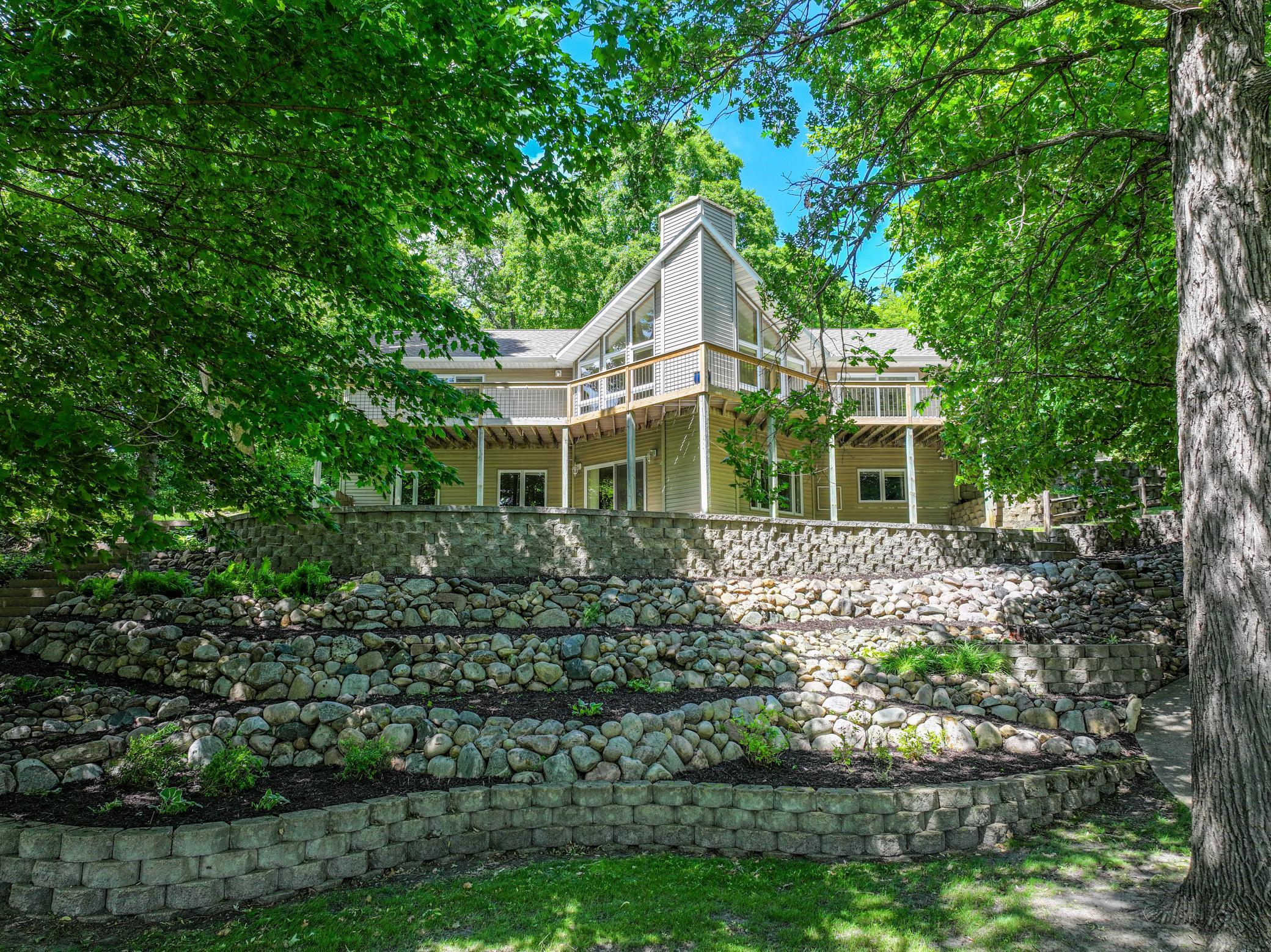 Life on lobster is better. Come tour this one-of-a-kind property where the lake comes to a point at the narrows. This unique property offers 400+ feet of shoreline and a park like setting that overlooks sunsets and sunrises. One side of the point is for swimming, one side is for boats and fishing. Some of the interior updates in 2026 include all new kitchen appliances and countertops, new paint throughout, and updated flooring in the entry and half bath. The wood floors have also been lightly refinished to make this stunning home move-in ready. The floor plan is fantastic and the setting is ideal; the cathedral ceilings with walls of windows offers you a panoramic view of the lake. The primary suite offers an attached office, that can be a flex room or additional bedroom. The basement offers a full walkout, real wood fireplace, wood box, and three more bedrooms, with a toy room and loads of storage. The home has been well maintained with a newer furnace and AC. The landscaping is ornate and elaborate, offering steps, a cascading sidewalk, and a golf cart trail all down to the level plateau Lakeside.Need more room? The three stall garage offers ample storage and parking, not to mention an additional one stall, detached heated and AC shop/garage.Come see what all the buzz is about on Lobster!