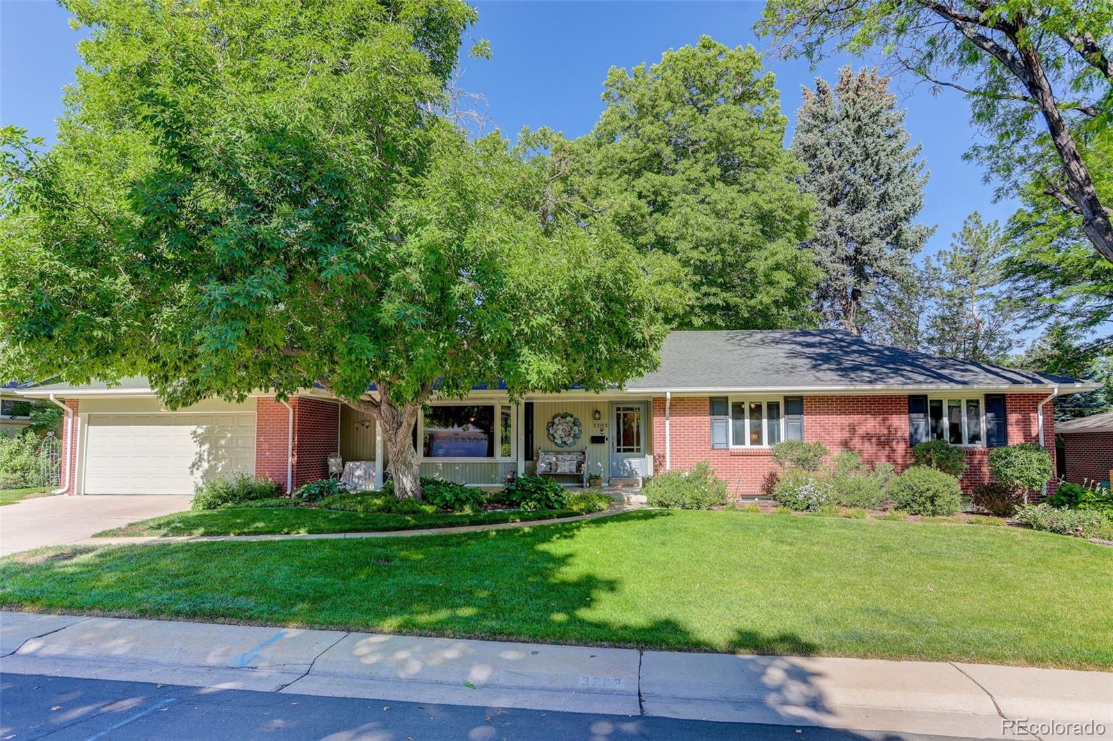 This fully remodeled and expanded Southern Hills brick ranch blends classic charm with a fabulously updated open floor plan in an unbeatable location. Situated on a quiet, tree-lined street just blocks from award-winning Slavens K-8 school, this exceptional home has great curb appeal and mature landscaping while sitting on an expansive 9,700sf lot. The welcoming living/dining room off the dedicated foyer features hardwood floors, a cozy fireplace and a beautiful bay window creating a warm and inviting first impression. A full kitchen renovation completed in 2015 has custom soft-close cabinetry, ample storage, designer Thermador appliances, large center island with prep sink, quartzite counters, bar seating and radiant heated tile floors. The kitchen is open to an inviting casual breakfast/dining area and den, all having access to the fabulous backyard. The primary bedroom/bathroom addition having ~460sf was completed in 2002. This area contains vaulted ceilings, corner gas fireplace, 5-piece en-suite bath, and huge walk-in with fabulous custom California Closet storage system. The main level also contains an updated bathroom, and two secondary bedrooms with hardwood floors, one with dual closets. The finished basement provides even more living space with a large family room, an office/flex space, a conforming bedroom with dual closets containing custom CA Closet storage/organizing systems, an en-suite bath, and a utility room. The home has Anderson windows throughout and Pella sliding glass doors with integrated blinds providing natural sunlight and views to the lush backyard for a true indoor/outdoor feel. The private picturesque backyard is truly spectacular with multiple areas to relax and entertain including a covered patio area, expansive uncovered pavestone patio with gas firepit, a huge deck with built-in seating and gas grill, and a sprawling lawn area with mature trees. Rarely does a home come along like this in one of Denver's most desirable neighborhoods.