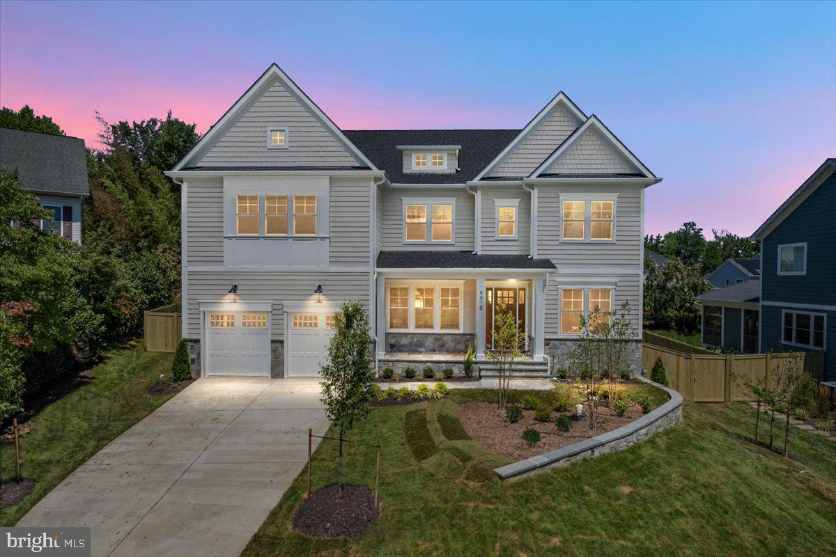 Just completed! Introducing 6610 Quinten Street — a new custom-built 7BR/6.5BA modern craftsman by McLean-based Focal Point Homes, tucked on to one of Falls Church's quiet cul-de-sacs. This well thought out floor plan features a two-tone chef's kitchen pairing Willow perimeter and Verde island cabinetry beneath Calacatta Antique quartz countertops, a custom wood hood, and a full Sub-Zero, Wolf & Cove appliance suite. Open main-level living is anchored by 10' ceilings, 4" white oak floors, Andersen wood windows, warm brass lighting, and a marble-look porcelain fireplace surround. The owner's suite indulges with a freestanding soaking tub, rain shower, dual lit vanities and a custom closet, while a finished lower level adds a bedroom, full bath, and dedicated fitness room. Outside, a covered flagstone rear porch overlooks the fully fenced, private backyard — all within walking distance of Haycock Elementary and Longfellow Middle, in the coveted McLean HS pyramid.