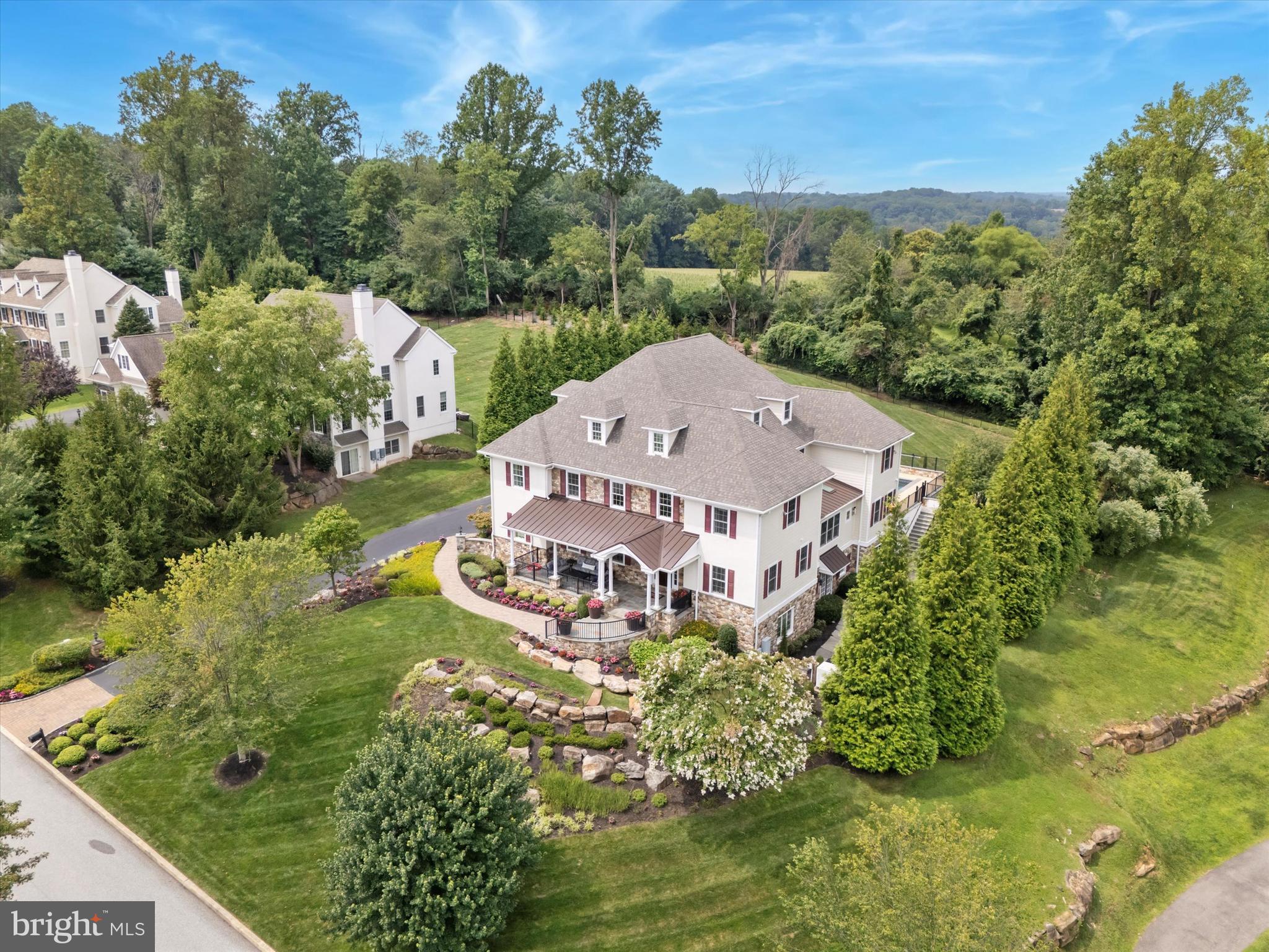 This exceptional custom built 3 story home offers 6 bedrooms, 7 full baths, 3 half baths and a 4 car garage, showcasing luxury craftsmanship throughout. The resort style backyard features a private in-ground pool and hot tub by Ted’s, plus a fully equipped pool house with vaulted ceilings, full bath, dressing area, gas fireplace, cabinetry, and mounted TV. Inside, a grand two story foyer with a curved staircase leads to a gourmet kitchen featuring a 10' x 6' island, level 5 granite, Wolf 6 burner range, dual Sub-Zero refrigerators, double dishwashers and a walk-in pantry. The kitchen flows into a 35' x 20' great room with beamed ceilings, hardwood floors, and built-ins. The finished walkout lower level offers a full bar/kitchen, gym rooms, an in-law/guest suite, and a 600+ bottle temperature controlled wine room. The luxurious primary suite includes a sitting room, two sided fireplace, beverage center and a spa inspired bath. Additional highlights include multiple bedroom suites, a third floor bonus/family room, geothermal 5 zone HVAC, whole house generator, integrated sound system, and a fenced rear yard. Offering exceptional amenities, abundant living space and premier entertaining areas both inside and out, this property stands as one of the area’s finest residences.