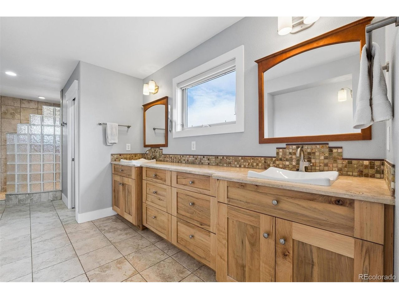 Discover a rare Custom Built Fort Collins retreat that blends modern design, effortless indoor-outdoor living, and forward-thinking energy efficiency, all set against the backdrop of Colorado's iconic Front Range. Positioned in one of Fort Collins' most desirable areas, this home offers quick access to the city's trail systems, vibrant dining, and everyday conveniences, while still feeling tucked away and peaceful. Inside, the open layout is bright and contemporary, anchored by a chef's kitchen with a gas cooktop, generous island, and walk-in pantry. A main-floor office provides the ideal work-from-home setup. Upstairs, the expansive primary suite feels like a private sanctuary, featuring double vanities, a large walk-in shower, and an adjacent loft perfect for a reading nook, fitness space, or lounge. Garage is oversized 2 car with plenty of room for extra storage and toys. Step outside and the home truly comes alive. The resort-style backyard is designed for year-round enjoyment with a built-in outdoor kitchen, covered patio, hot tub, and private pool, an entertainer's dream framed by stunning sunset skies. Energy efficiency is a standout feature: owned solar, room-by-room mini-split heating and cooling, and radiant heat keep utility costs remarkably low while maintaining exceptional comfort. A beautifully designed Fort Collins home where modern living, sustainability, and outdoor enjoyment come together seamlessly.