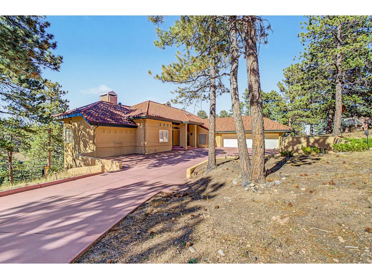 Experience expansive mountain living in Riva Chase, where sweeping views, distinctive Southwestern design, and nearly three acres of scenic grounds create an exceptional Genesee retreat. Offering over 4,631 square feet, five bedrooms, five bathrooms, and a three-car garage, this residence pairs generous living spaces with some of the community's most captivating vistas from two expansive decks. Majestic deer & elk frequent the surrounding landscape, bringing Colorado's natural beauty close to home.Soaring vaulted ceilings, terracotta tile, warm hardwood flooring, and brand-new carpet complement the home's inviting southwest architectural character. The kitchen features luxury appliances and leathered granite countertops, with a breakfast nook for relaxed mornings and a spacious formal dining room, with a butler's pantry, for memorable gatherings.The primary suite offers a peaceful escape with an luxurious five-piece bathroom, a jetted tub, and windows framing the valley below. Downstairs, a home theater space and wet bar provide room for movie nights, entertaining, and unwinding.Outside, the spacious driveway includes an area for guest parking or basketball, while an additional recreation area offers possibilities for a volleyball court or winter hockey practice. A steel roof with terracotta appearance adds lasting appeal and durability; its potential hail and fire-resistance benefits and any insurance savings should be confirmed with the manufacturer and insurer.Competitively priced for its size, setting, and amenities, this property presents an outstanding opportunity to enjoy the Riva Chase lifestyle. Move in and appreciate its distinctive character, or bring your own design vision to personalize the generous spaces and build on the home's long-term potential. Remarkable views, room to spread out, and an extraordinary lot make this a compelling value in mountain luxury living! Come see it today before it becomes someone else's slice of paradise!