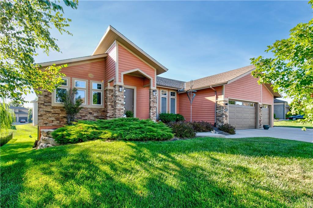 Extraordinary custom reverse 1.5 design along beautiful Raintree Lake's north shore, enjoy Cass County luxury lake-style living in accredited Lee's Summit R-7 school district.  Abundant custom cabinetry throughout, car-siding vaulted ceilings, hard to find walnut hardwood flooring, floor to ceiling fireplace facing; an array of upgrades literally in every room.  This is the home-entertaining enthusiasts dream come true, uniquely designed to host your largest gatherings.  Kitchen features oversized center island, dual sinks, a breakfast area and walk-in pantry with desk space.  Main-level primary bedroom with spacious walk-in closet attach's to laundry room.  Fully finished lower-level with walk-out features 3 bedrooms, 2 full bathrooms and partial kitchen area adjacent to oversized family room.  Covered deck and covered lower-level patio.  Lower-level garage is 407 s.f.  Exceptional lake community with good variety of on the water activities right outside your door.