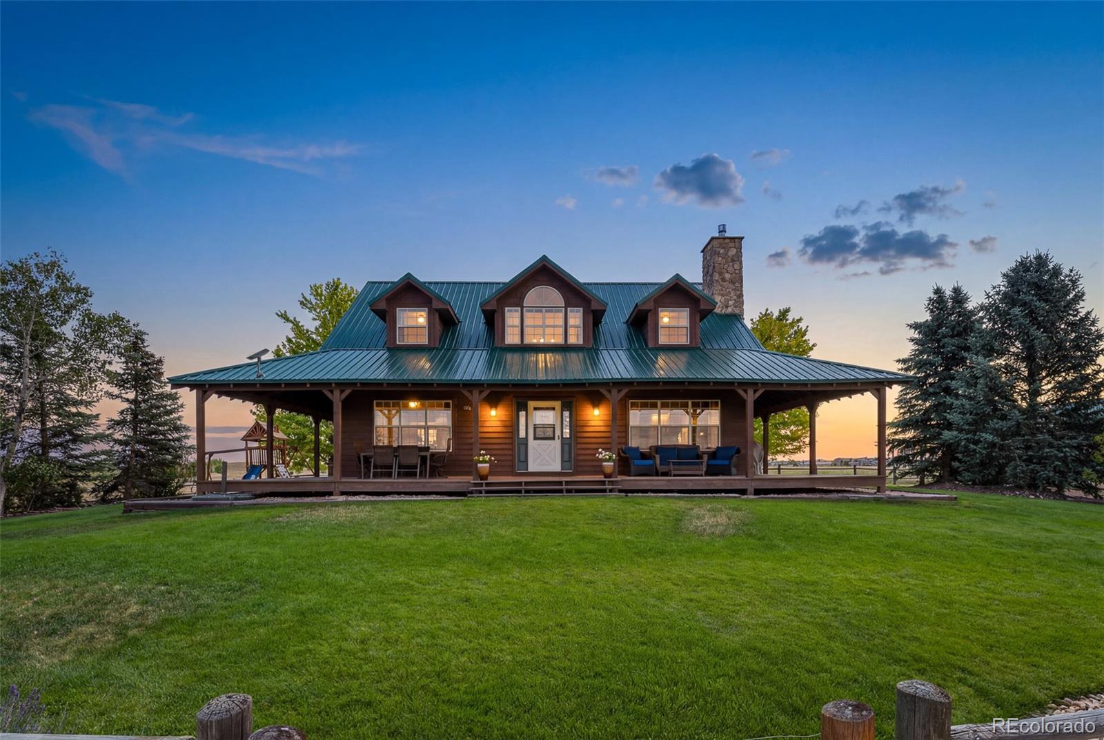 Discover the freedom of Colorado acreage living without sacrificing convenience at this exceptional top of the hill 18-acre estate. Ideally located just minutes from I-25, premier shopping, dining, and everyday amenities. Beyond the semi-private drive you'll discover a beautifully maintained home that embraces the warmth and character of Colorado country living. The expansive wraparound porch provides the perfect setting to enjoy spectacular sunrises, mountain sunsets, and peaceful views in every season. Enjoy the unobstructed mountain views spanning the entire Front Range from Wyoming to Colorado Springs. Interior space includes soaring ceilings, expansive windows, warm wood finishes, and a dramatic stone fireplace contributing to an inviting atmosphere filled with natural light. Spacious living areas blend rustic charm with everyday comfort, making the home ideal for both relaxing and entertaining. Designed for equestrian and outdoor enthusiasts, the property features fenced paddocks, horse facilities, detached outbuildings, a large shop with 220-volt power, covered RV storage, and ample space for equipment, trailers, recreational vehicles, or future improvements. Whether your vision includes horses, hobby farming, additional barns, or simply room to enjoy Colorado's open spaces, this versatile property offers endless possibilities. Lovingly maintained and move-in ready, the home also presents an exciting opportunity to personalize the existing residence or explore the potential to build an additional home on the property (subject to county approval), creating a legacy estate tailored to your vision.Relax around the outdoor fire pit, entertain beneath Colorado's endless skies, and enjoy the peace, privacy, and beauty that only acreage living can provide. Underground utilities preserve the spectacular views, while mature landscaping enhances the property's serene setting