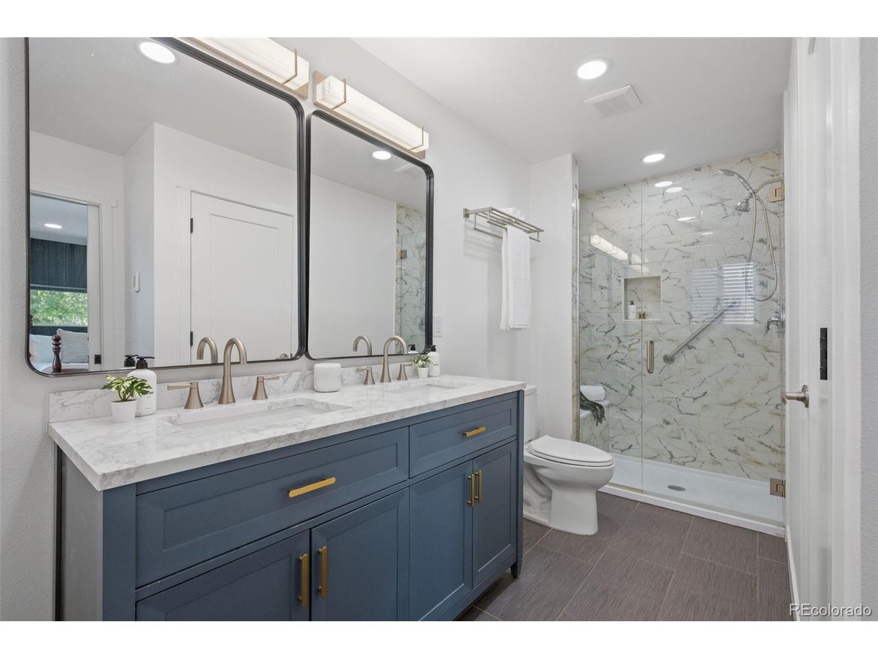 Welcome to 2740 S Madison Street, a thoughtfully updated ranch-style home in Denver's Wellshire neighborhood with 3 bedrooms, 2 bathrooms, and 1,124 square feet of refreshed single-level living. Inside, hardwood floors and a traditional ranch layout pair with a major 2025 renovation that brought a fully remodeled kitchen, updated bathrooms, a new primary suite, and modernized systems throughout the home.The kitchen was fully remodeled in 2025 with quartz countertops, brand new cabinets, new stainless steel appliances, a range with hood, under-cabinet lighting, and a sink window overlooking the backyard. A custom hydraulic spring cabinet adds smart storage for a stand mixer or small appliance setup, keeping the kitchen both functional and streamlined. Both bathrooms were also updated in 2025, including a primary ensuite with double vanity, heated floors, and modern finishes.Recent improvements within the last 16 months include new rewiring, plumbing, heat pumps for the home and garage, tankless water heaters for the home and garage, new gutters, new washer and dryer, and new kitchen appliances. The furnace was relocated from the crawl space to the former linen closet for easier maintenance and filter access. The attached garage was converted into the primary bedroom and bathroom, and a new detached garage was built with an attached workshop, baseboard heating, and split-unit cooling.Outside, enjoy a private backyard with garden beds and ongoing front yard xeriscaping designed to reduce water consumption. Set just 4 minutes from Wellshire Golf Course and 3 minutes from Robert H. McWilliams Park, this home offers updated living in a classic southeast Denver neighborhood with easy access to nearby parks, recreation, and everyday conveniences.