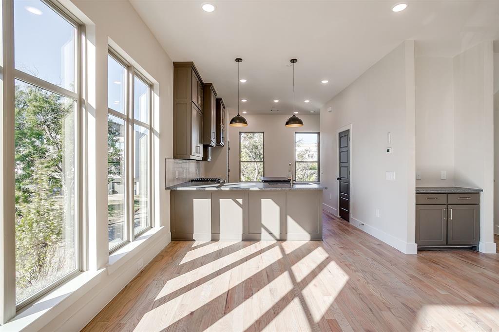 ** OFFERING 1 MONTH FREE WITH MOVE IN PRIOR TO 5-1-25! ** Experience the pinnacle of modern design & urban sophistication at Linwood Quarter, a boutique townhome community perfectly situated in one of FW’s most walkable & vibrant neighborhoods. Thoughtfully designed and built, each residence at Linwood Quarter delivers a rare balance of style, functionality & location - without compromise. Linwood Quarter offers three stunning design packages - The Terra, The Noir & The Lumen - each inspired by a distinct aesthetic and lifestyle. This unit features The Noir, emphasizing Moody Organic design: rich wood tones, dramatic stone surfaces, & dark, evocative accents that create a bold yet welcoming atmosphere. Every inch of this home is crafted with intention, blending luxury and practicality for an effortlessly elevated living experience. Inside, the curated interiors reveal custom cabinetry, natural stone countertops in exquisite quartzite and leathered granite, and real hardwood floors. High-end Delta plumbing fixtures & stainless steel GE appliances - including GAS ranges -offer both form & function, while the Energy Star efficiency rating and spray foam insulation ensure year-round comfort and performance. Expansive 10-foot ceilings on the main level! The primary suite offers the walk in shower of your dreams, dual vanity and walk-in closet. LOTS of storage! Bonus built in desk workspace. The oversized garage easily accommodates SUVs, bikes & extra gear. Upstairs, the private rooftop terrace invites you to unwind or entertain against the backdrop of panoramic downtown Fort Worth views.Linwood Quarter is steps from Linwood Park, walking distance to the new $1.7B Westside Village & UNT Health Science Center, & just three miles from TCU & TAMU Law School. Here, refined design meets unmatched location - creating an urban sanctuary where luxury feels effortless & every detail reflects your sense of style.