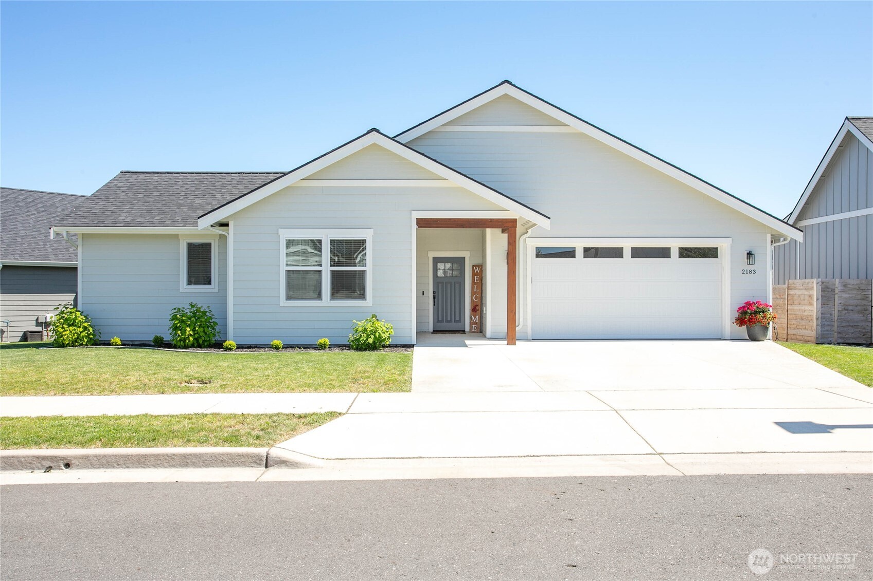 Lovely like-new home in newer eastside neighborhood w/gorgeous mountain, hillside & pastoral view vantage point. Zero step entry greets you entering this split living layout home. Enjoy luxury vinyl plank flooring throughout, no carpet at all! Spare bedrooms, extra-large utility room & full bath in front of home separating nicely from main living area & owner's suite tucked in back corner. Beautiful kitchen w/lower wood cabinets, painted upper & black matte granite. Vaulted living room boasts extra-large sliding glass door & views of Twin sisters. Owner's suite also has views, 3/4 ensuite bath w/linen & large walk-in closet. Fully fenced yard, good size back patio, AC, irrigation & garden space complete this move-in ready home.