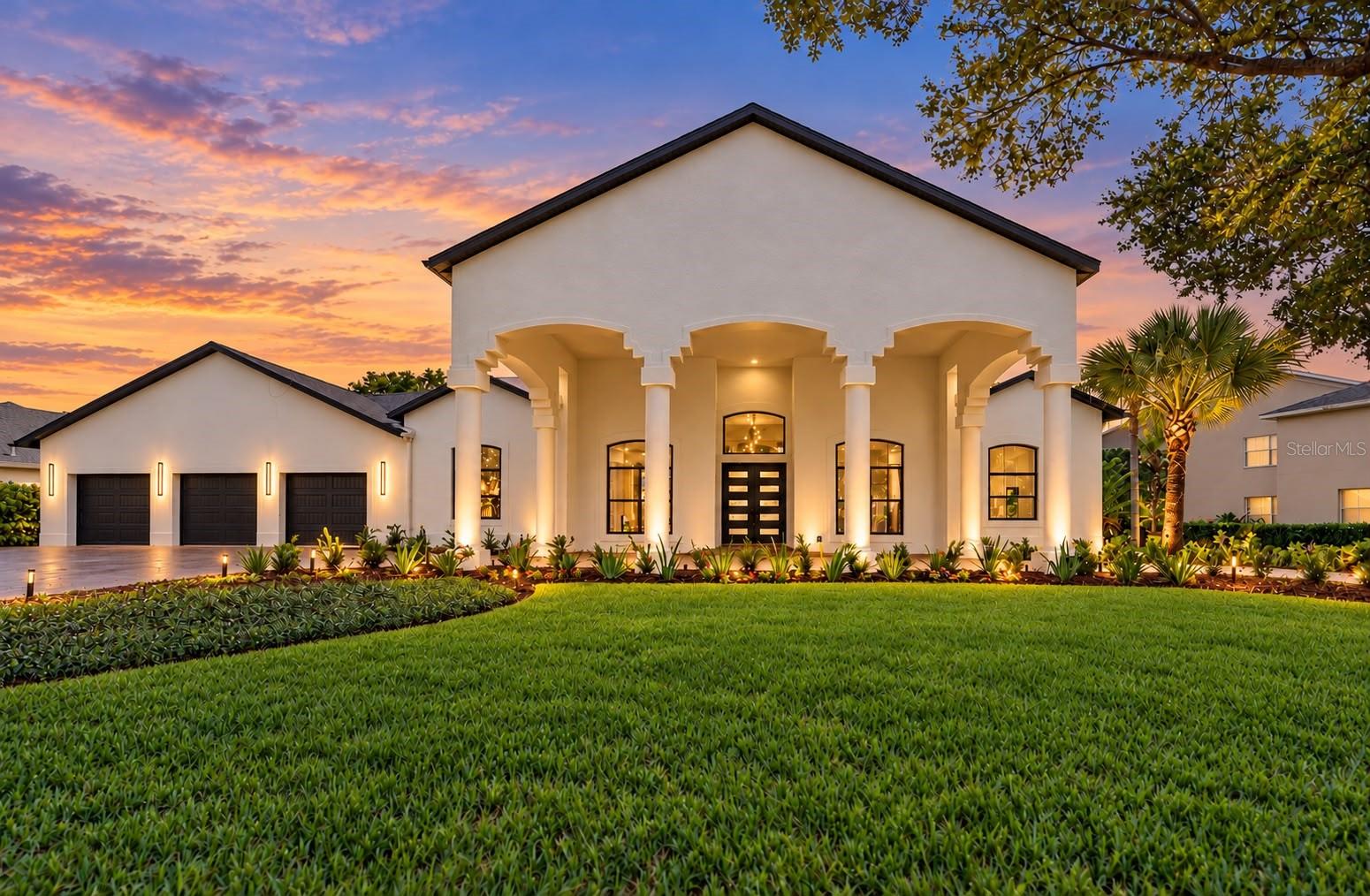 Under contract-accepting backup offers. Experience contemporary elegance at 5021 Wesley Dr, located in Huntington, an exclusive gated community within Tampa Palms featuring only a small collection of homes. Fully remodeled with a modern contemporary design, this residence makes a lasting first impression with its dramatic covered drive-through entrance, expansive driveway, and three-car garage. Magnificent mature oak trees and thoughtfully designed landscape lighting create beautiful curb appeal, day and night.Inside, the contemporary kitchen features built-in appliances, while a formal dining room offers an elegant setting for entertaining. A striking fireplace with an accent wall anchors the living area, and integrated speakers in the living room and patio enhance the experience. The spacious primary suite is complemented by two additional suites with private bathrooms, including one that can serve as an in-law suite. Custom closets will be designed and installed to the buyer’s preferences, included in the purchase price.Enjoy Florida living with a sparkling pool and spa, smart color-changing pool lighting, and a new outdoor kitchen designed for memorable gatherings. Peaceful lake views across the front, with no homes directly opposite, add to the home’s distinctive setting. Contemporary finishes, impressive outdoor spaces, and a grand covered arrival come together in this exceptional home in Huntington at Tampa Palms.